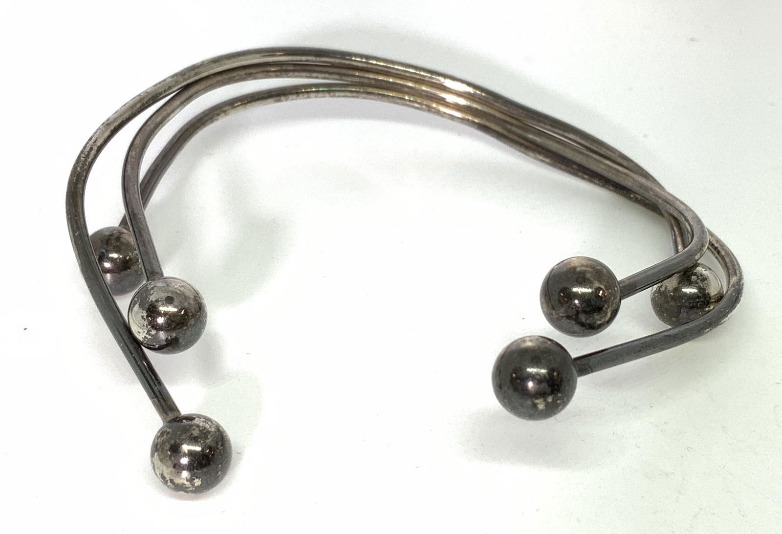 Signed Silver Ball Sculpted Vintage Cuff Bracelet: Artisanal Sterling silver bracelet. Tested positive for 925 Sterling with puriTest kit, no marks noted. Possibly antique. 3 wires of different lengths soldered at end with a silver ball accent. 2.5 in