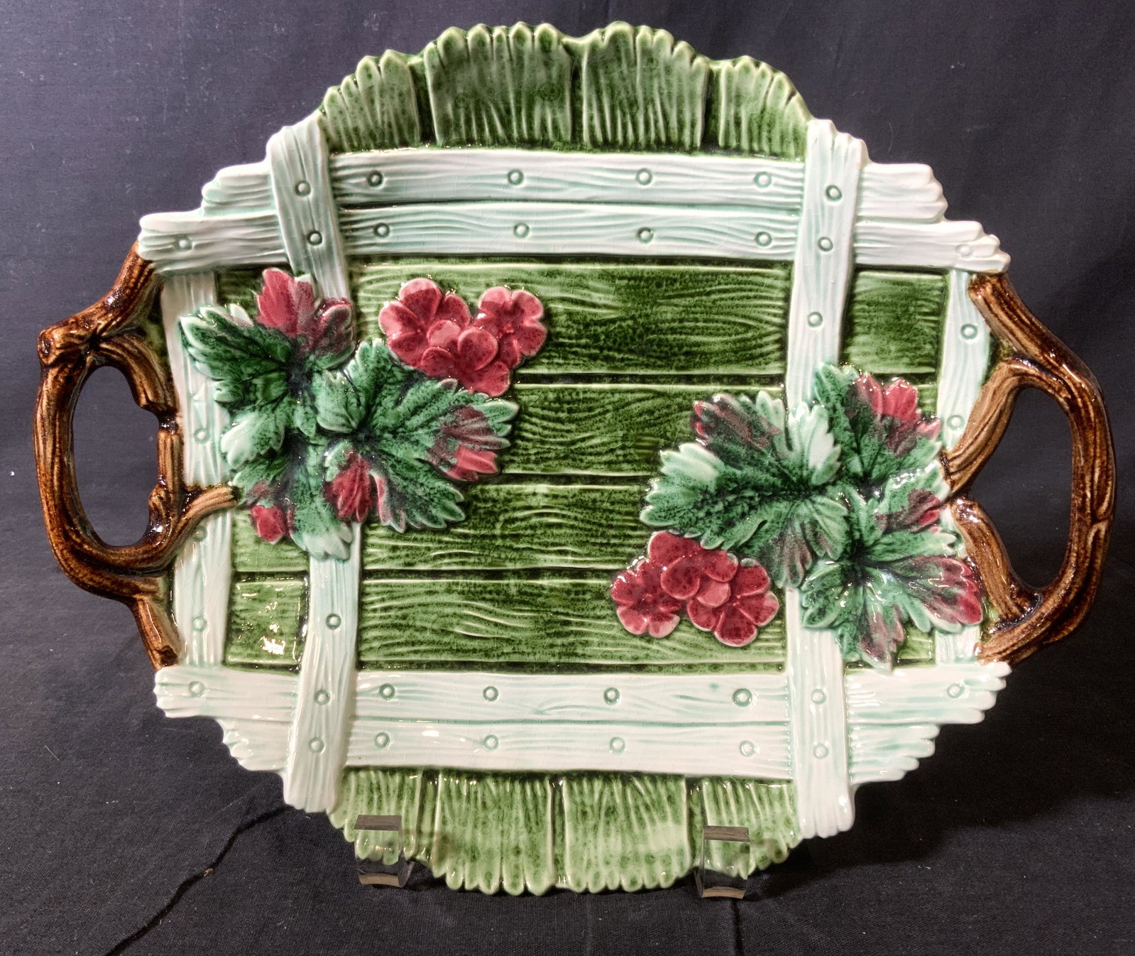 MOTTAHEDEH Italian Porcelain Dish: Underside is marked MUSEUM MOTTAHEDEH REPRODUCTIONS MADE IN ITALY. Dish contains green & red toned floral & leaf detail. Sides of dish have brown toned handles. Piece measures approx 11 inches long 9 