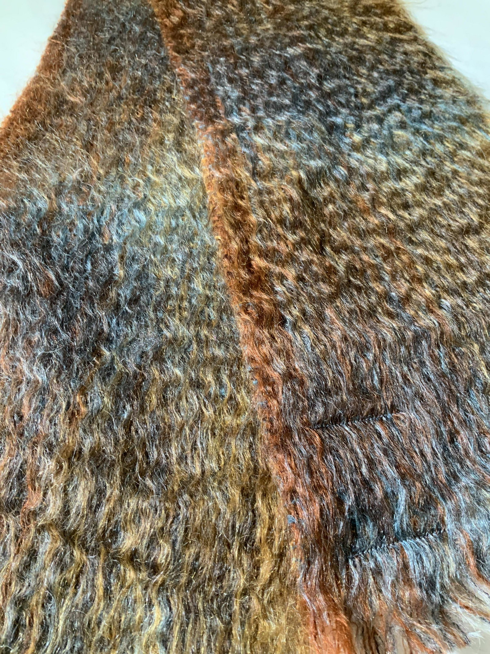 MOHAIR LOOM SCARF, Calzeat of Scotland: Soft hair mohair scarf, Made in Scotland, designer label affixed to garment, reads CALZEAT OF SCOTLAND. 70% mohair, 30% new wool. Dyed colors of blues & auburn. 9.75 x 64 in. Unisex scarf, Scottish Mo
