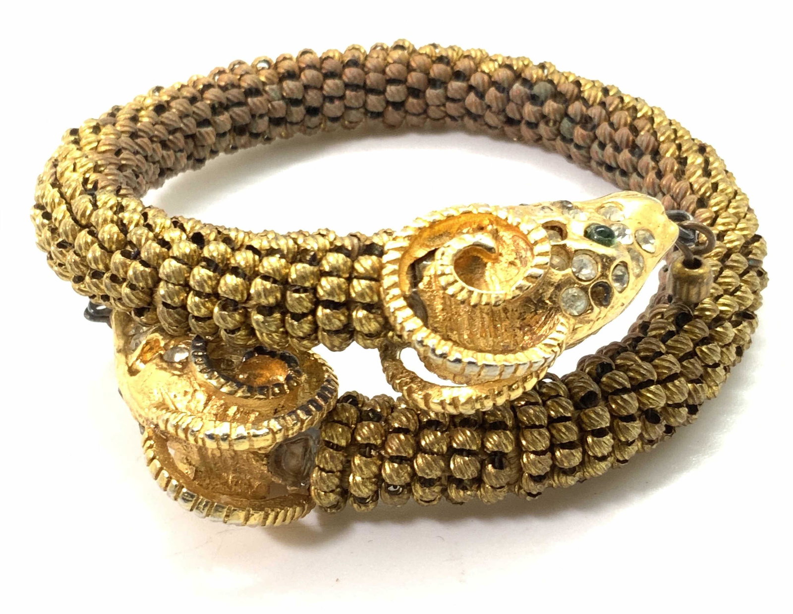 DOUBLE RAM HEAD Beaded Rhinestone Bracelet: A gold tone metal beaded cuff bracelet depicting two ram heads on either end. The rams have intricate etched details in their horns and their faces are studded in colorless, faceted rhinestones. Each 