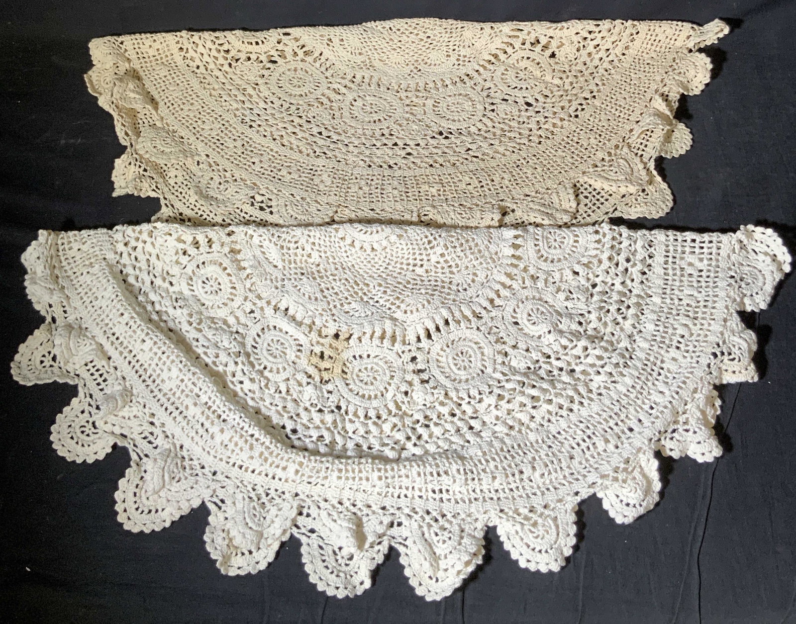 Lot 2 Vintage Circular Crochet Centerpiece Doilies: Two pieces of vintage crochet fabric textile doilies. Circular in shape. Off white coloring. Can be used as centerpieces on a table, furniture covers, and more. Mild discoloration. Approx. 30 x 30 in.