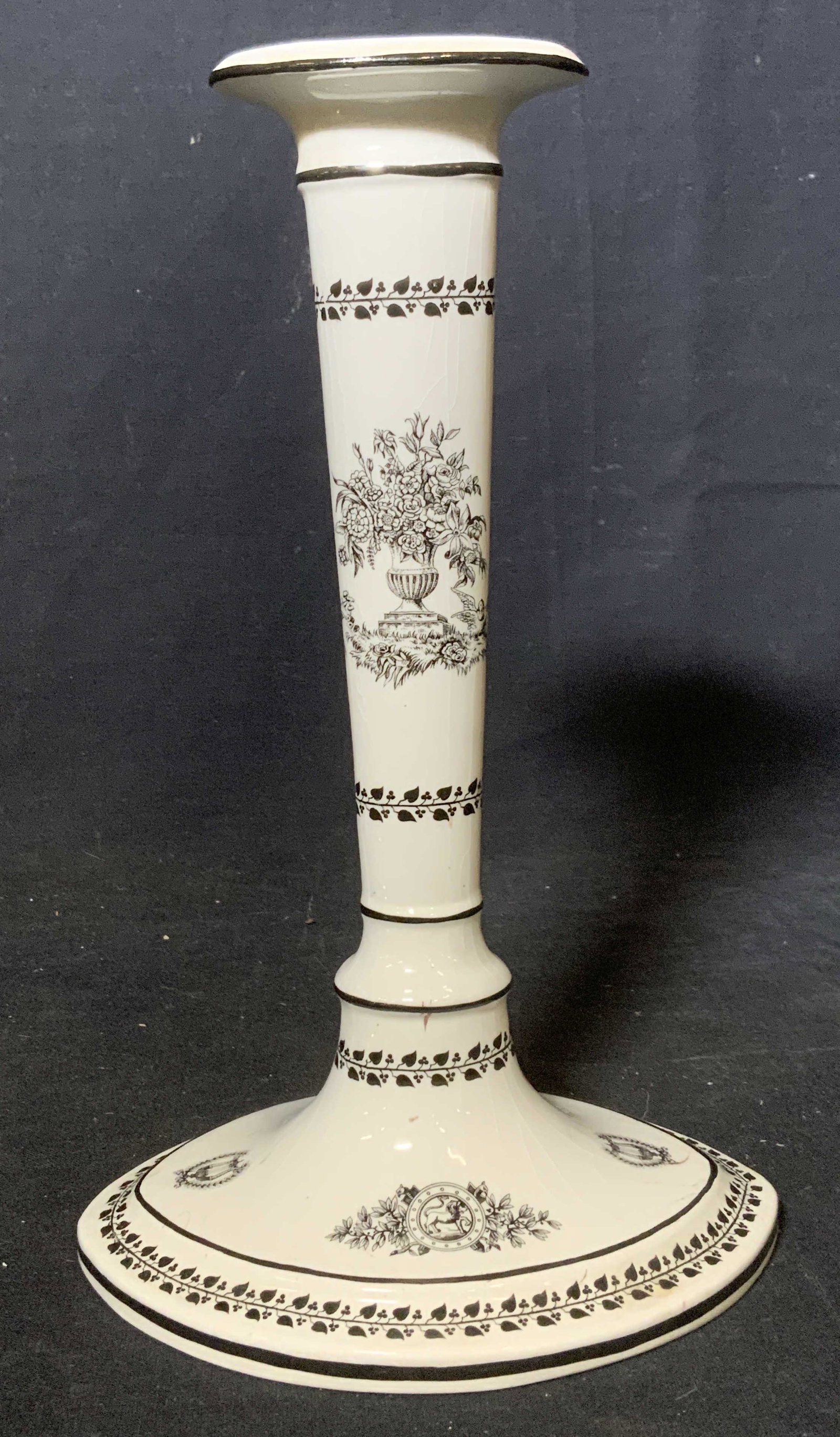 MOTTAHEDEH Ceramic Candlestick Holder: Vintage ceramic candlestick holder, white ceramic with black detailing. Decorated with illustrations depicting planters filled with floral bouquets, base decorated with medallions depicting lions and 