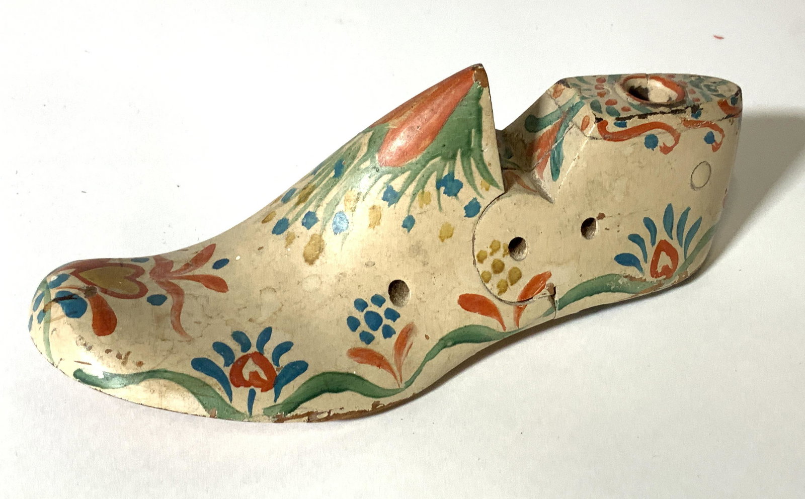 Antique Dutch Cobbler’s Wood Shoe, Hand Painted: This is an antique, hand carved out of wood, and hand painted, Dutch Cobbler Shoe mold. Underside has a metal heel nailed to wood. Early 1900s Dutch decor. 7 x 2.75 in. Dutch Cobbler Shoe, Hand Painte
