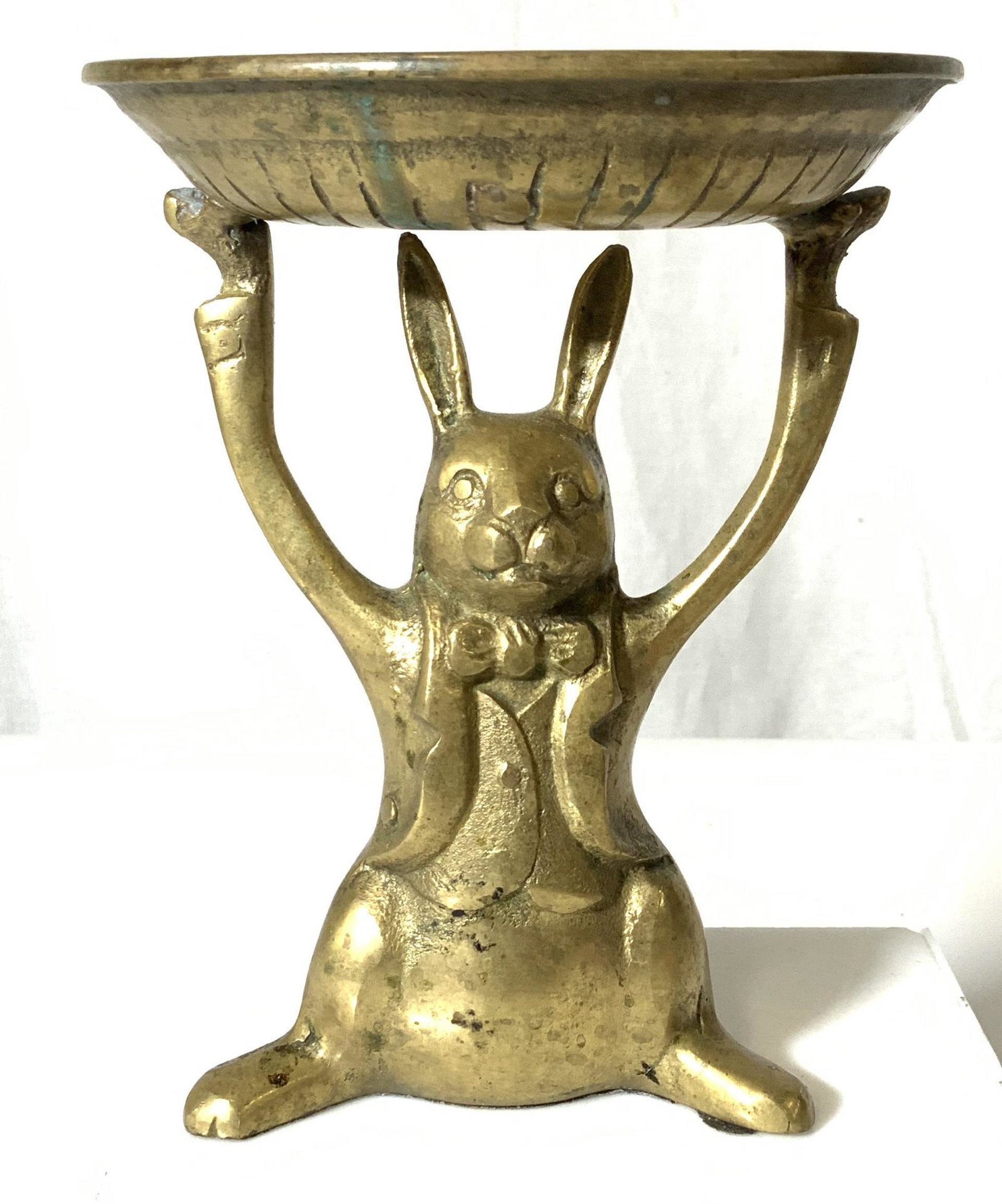 Vintage Brass Rabbit Vessel / Candlestick: Handsome rabbit figural in dovetail suit jacket and bow tie, holding up a dish with arms. Original use likely a candleholder, up cycle for other uses. Underside shows a lower part of rabbit cement / c