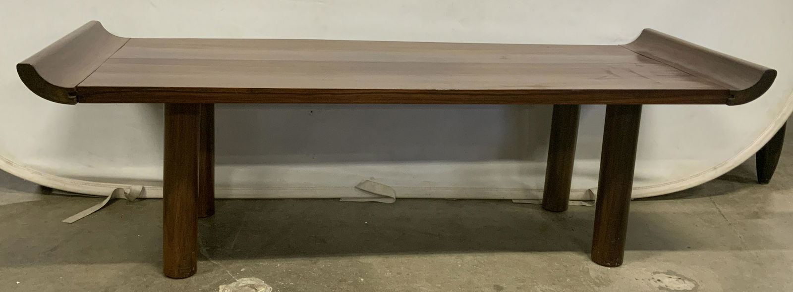 Vintage Asian Style Teak Bench: Vintage Asian style teak bench / coffee table. Bench ends curl upwards, rests on four cylindrical legs. Measures approx 16.5 inches H, 52.5 inches W, and 19 inches deep. Wear is consistent with age an