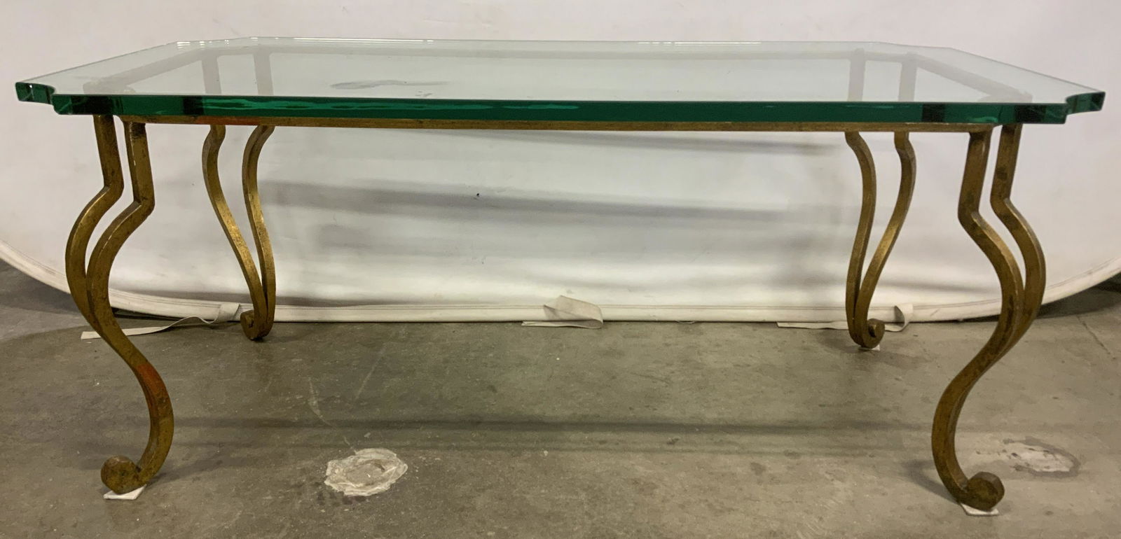 Vintage Gilded Metal Glass Topped Coffee Table: Vintage glass topped coffee table. Frame is metal, table legs are cabriole style. Frame is colored with gilt paint. Wear is consistent with age and use, some of the gilt paint has worn, several pads s