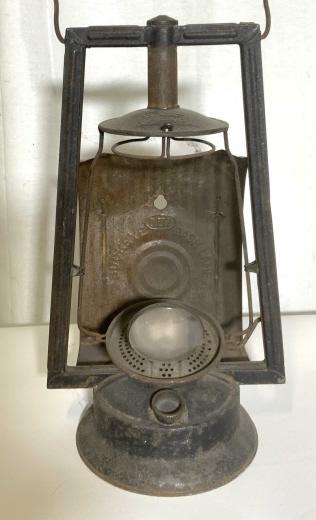 Antique DIETZ Buckeye Dash Lamp: Antique buckeye dash lamp. Top of lamp reads as DIETZ, lamp interior reads as DIETZ BUCKEYE DASH LAMP. Lamp is crafted from metal, lens is glass. Measures approx 19 inches H, and 8 inches W. Wear is c