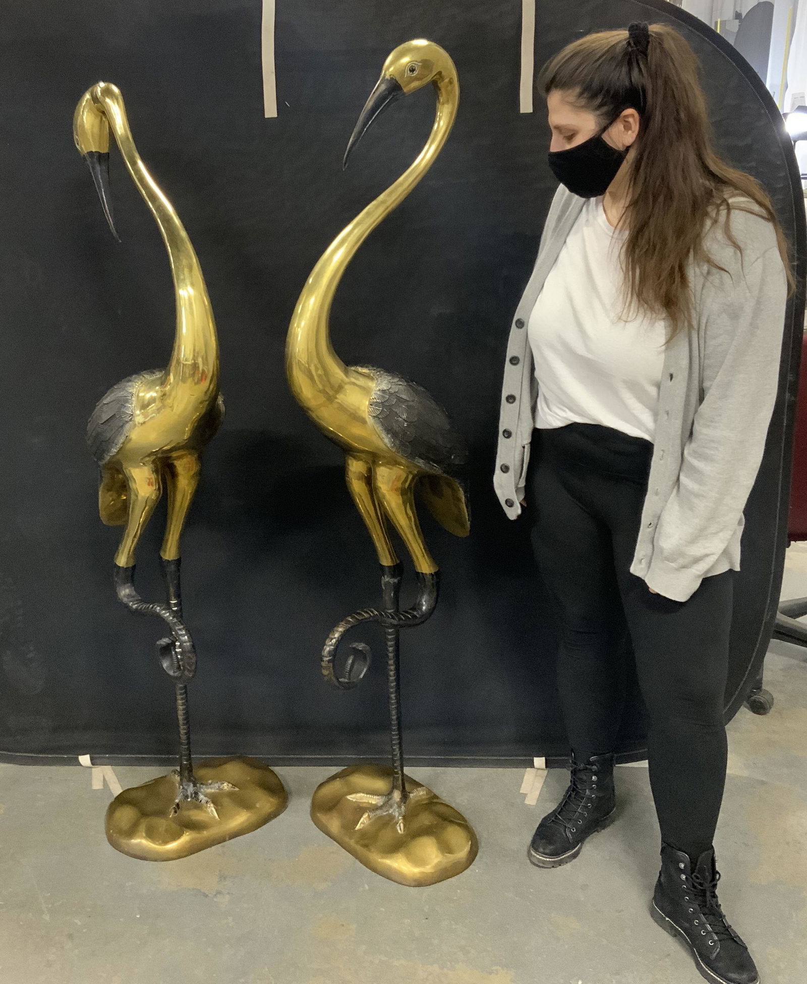 Pair Grand Vintage Brass Flamingo Sculptures: Pair of vintage brass flamingo sculptures. Legs, beak, and eyes appear to be hand painted. Wear is consistent with age, some paint has worn. Pieces are weighty and grand in stature. Lawn ornament, gar