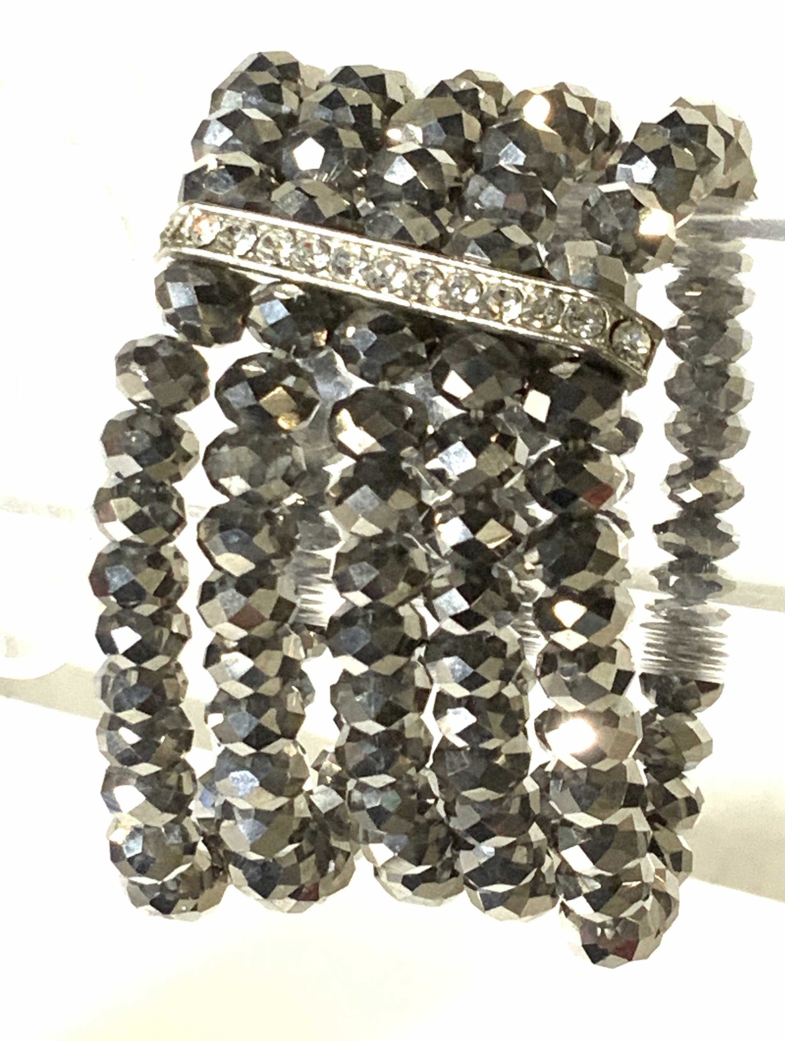 Metallic Multi Strand Rondelle Stretch Bracelet: Bling Bling! Metallic gun metal toned rondelle beaded bracelet, multi strand stretch with accented crystal bar. Bracelet width 1.5 in. Hand strung. One size fits most. Bracelet, Cocktail jewelry, Mult