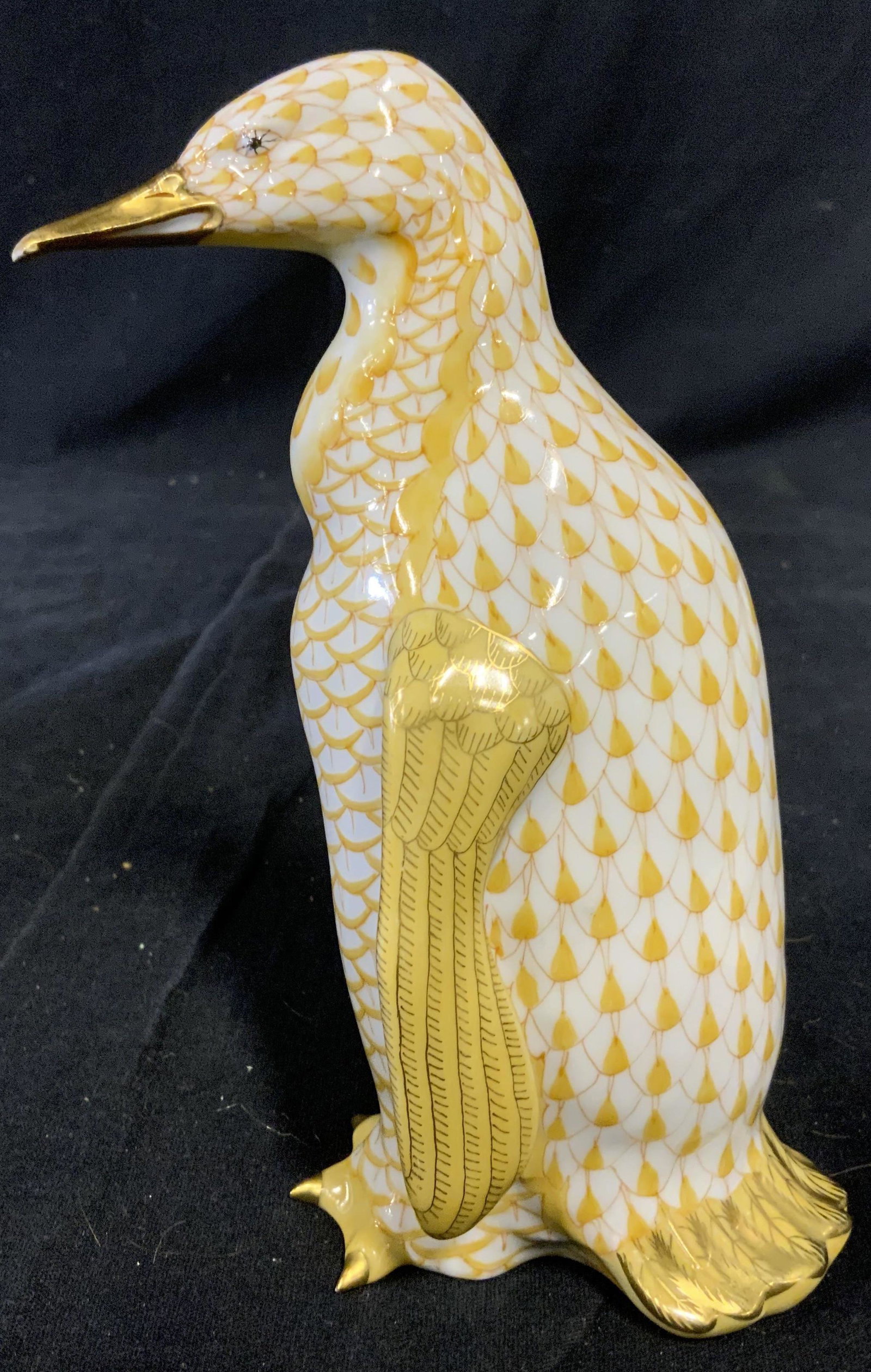 HEREND HUNGARY Handpainted Ceramic Penguin Figural: Hand painted HEREND figural. Depicts a Penguin, painted in amber tones, feathers on its wings and tail, as well as its beak and toes are colored with gilt paint. Underside reads as HEREND HUNGARY HAND