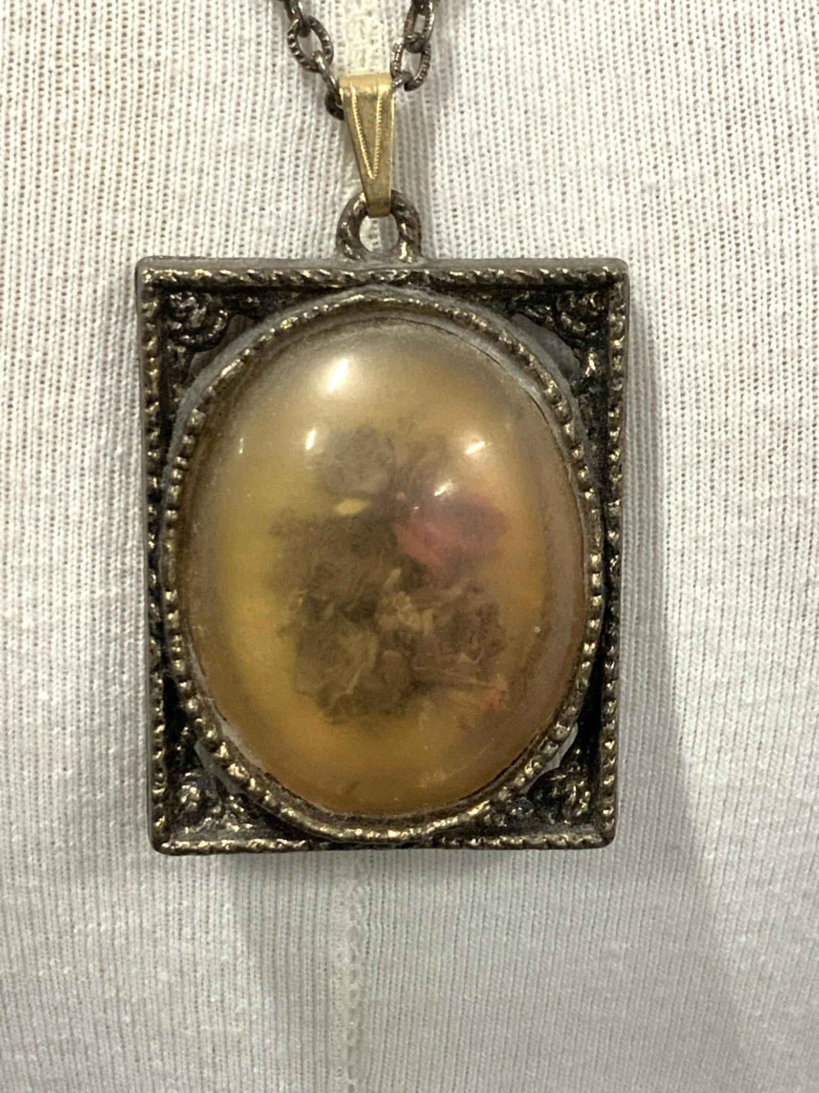 Vintage Dried Flower / Mirror Pendant on Chain: 22 in. Chain , rectangular pendant with dried flowers under dome. Vintage condition consistent with light exposure and age- darkening of plastic dome. Other side on pendant is an oval mirror. Pendant 