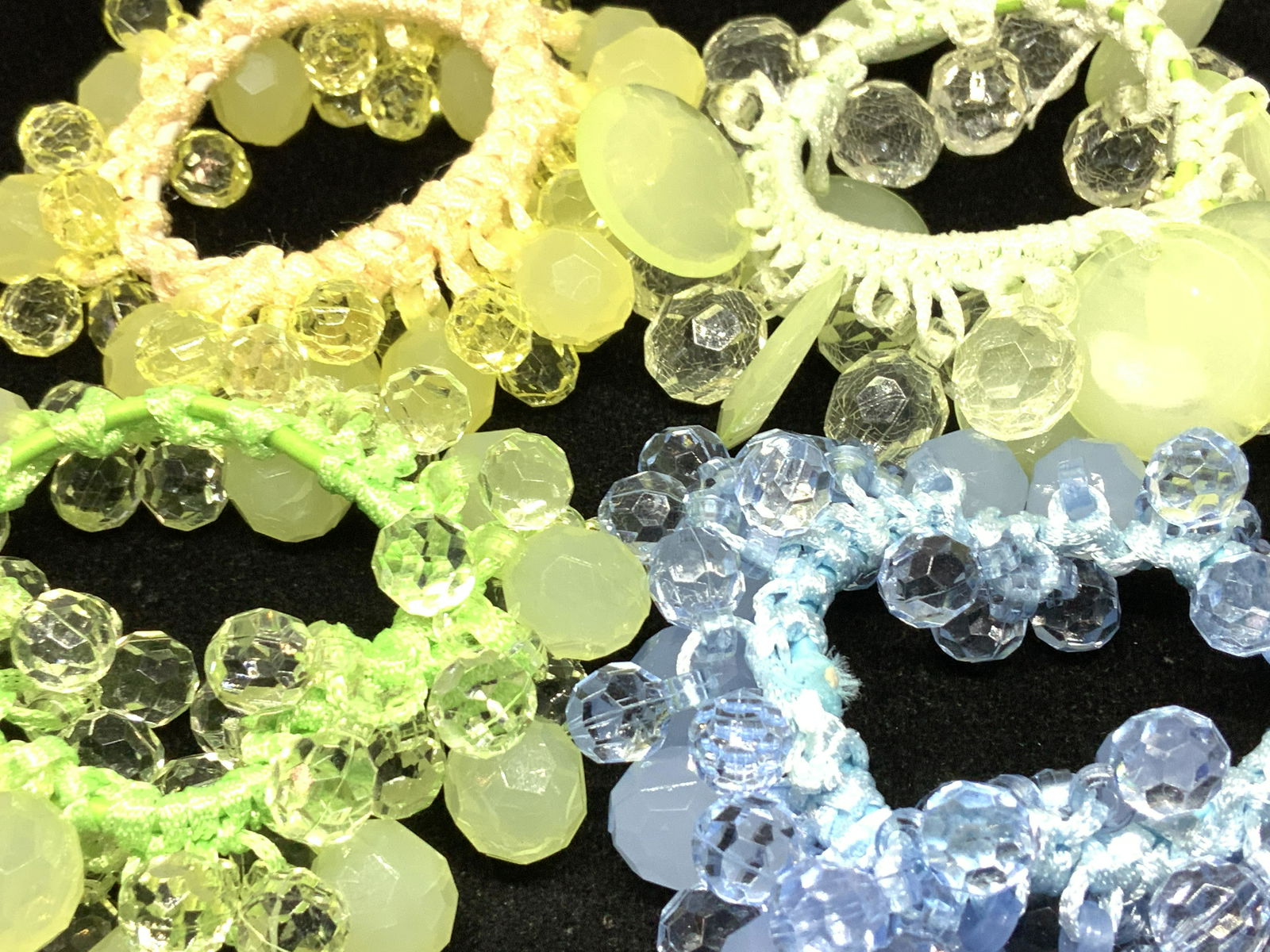 Group 4 Colorful Dangle Bead Bracelets Jewelry: Handmade stretch bracelets with colorful faceted shaped beads, crochet on to stretch band. Bright colors include yellow, blue, green and lime. Some bead semi opaque, some translucent. Come in a beauti