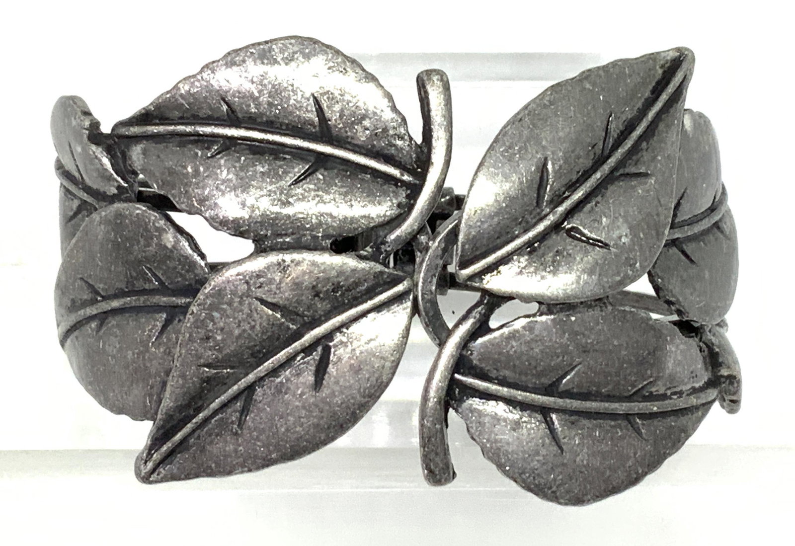 Leaf Art Nouveau Pewter Cuff Bracelet Jewelry: Multi leaf motif, expressing that early 30’s and 40’s naturalism. Cuff opens from top and hinges open. Pattern 1.5 in. Wide. Bracelet 2.25 in diameter. Sculptural Cuff Bracelet, Leaf Motif Cuff, A