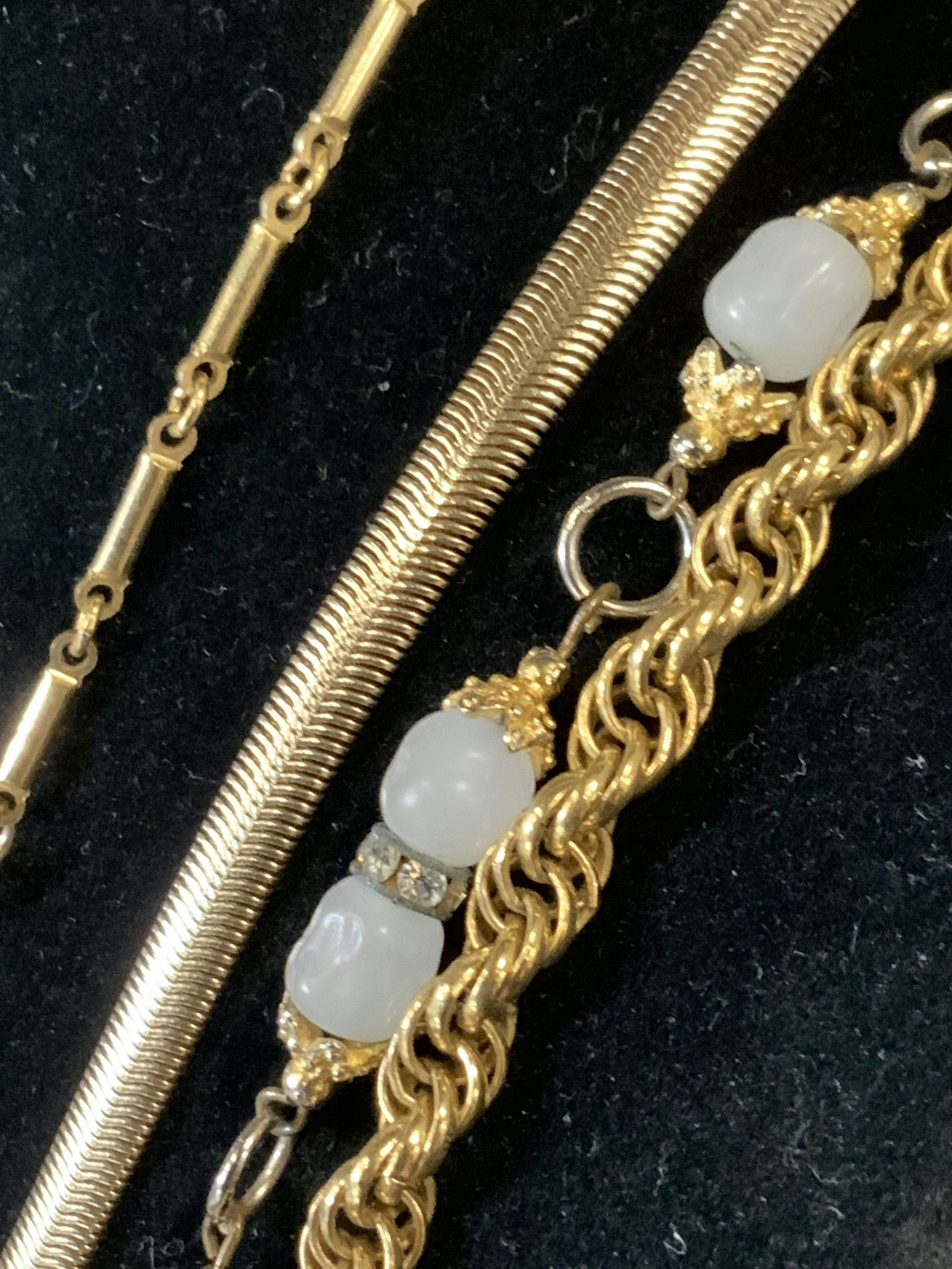 Group 4 Ladies Everyday Necklaces, MONET & M: Long chain necklaces, all gold tone metal based. Two Signed Designers- Vintage Twisted Rope chain with Signed Charm ‘ MONET’, 32 in. Luscious long SPIGA CHAIN w/ Warm White rounded square Lucite p