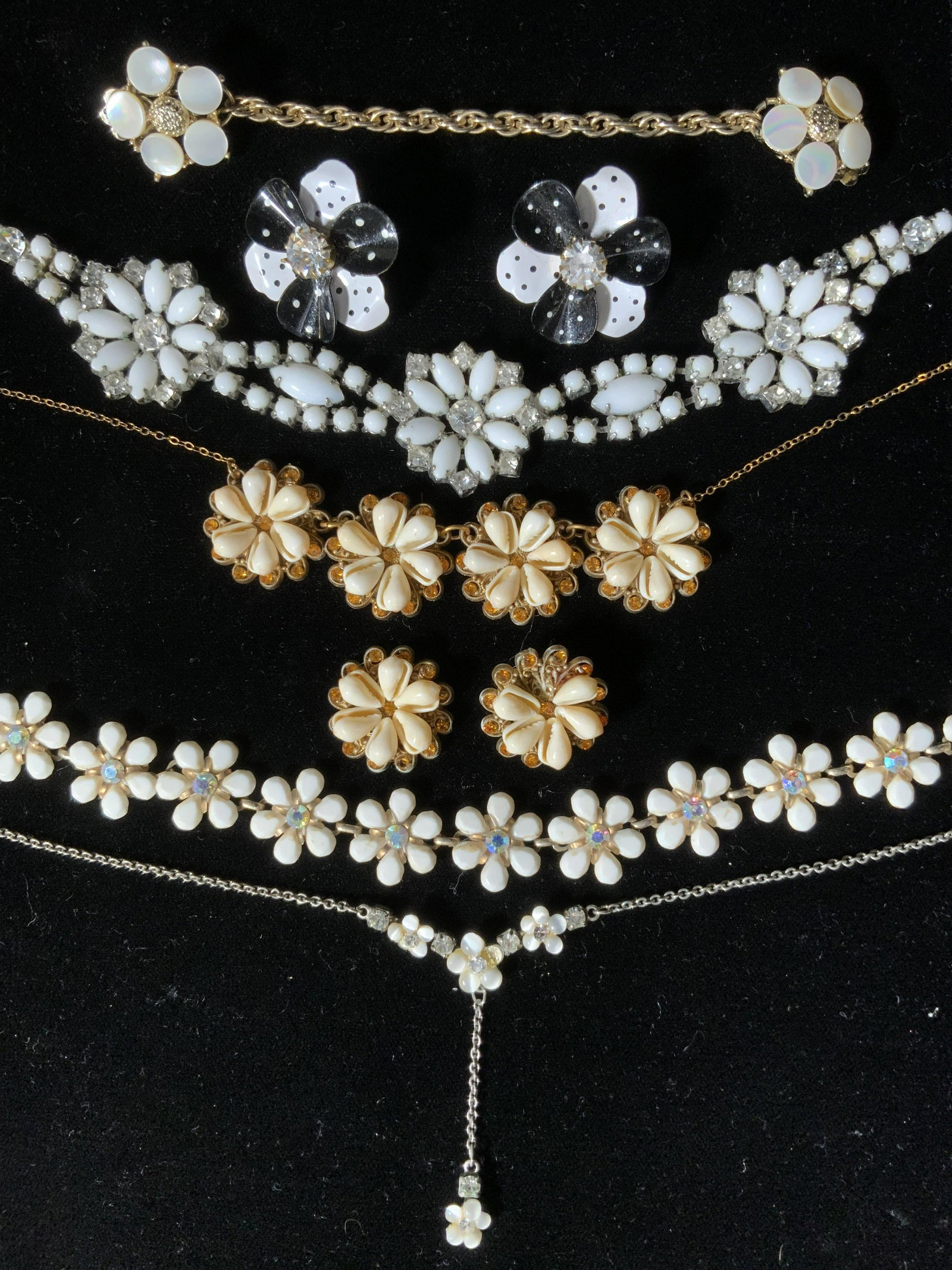 Lot 7 Floral Motif Necklaces & Earrings, Jewelry: Lot 7 Floral Themed Necklaces & Earrings, no apparent inscriptions or marks, black and white earrings measure 1 1/4 inches in diameter, sweater clasp measures 5 5/8 inches long, larger white flower ne