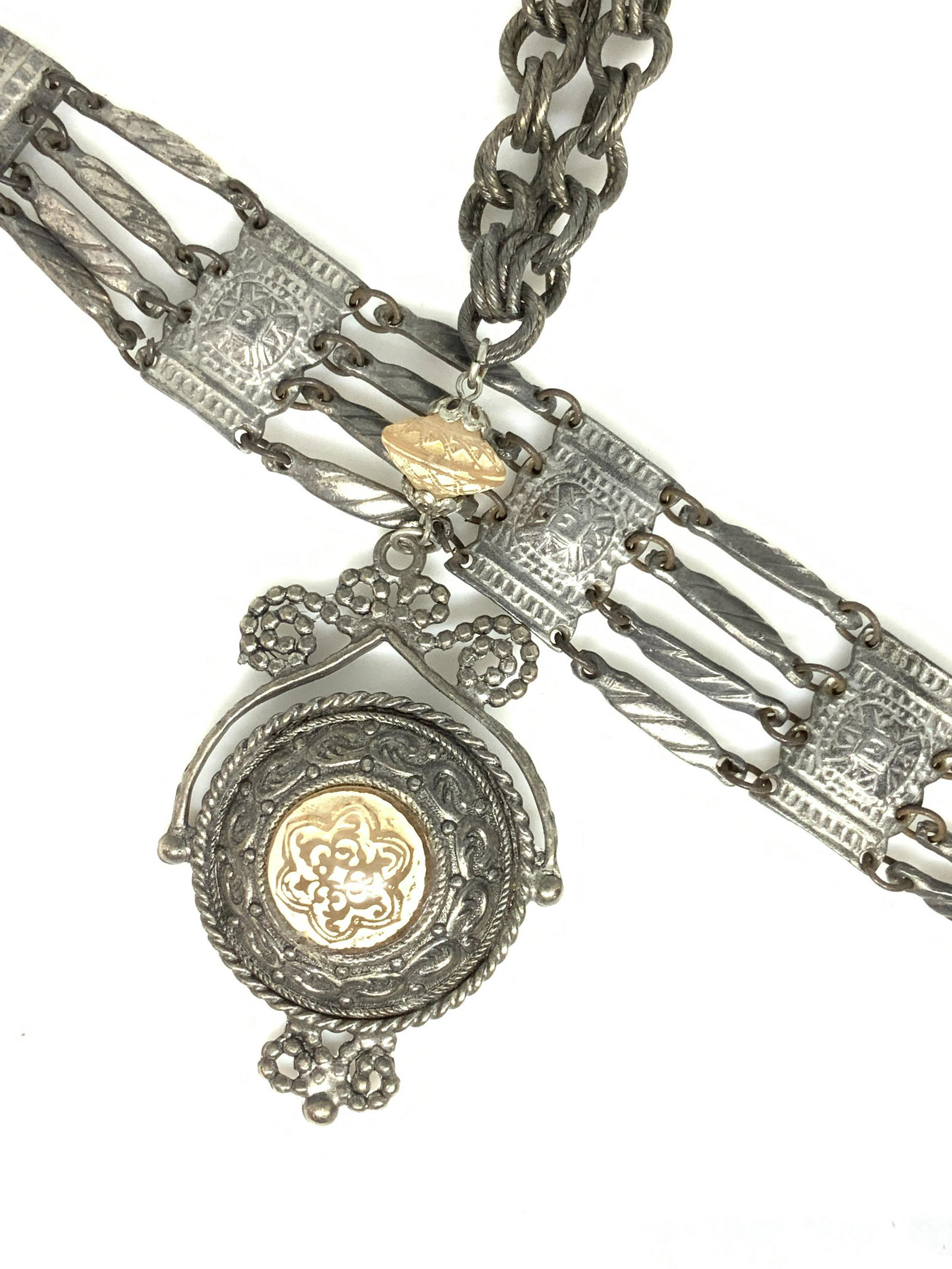 Lot 2 Brutalist Etched Metal Necklace + Bracelet: Vintage pieces in silver tone, chased in relief patterns , both with a goth/ brutalist/ medieval / or pre Colombian style. Multi link bracelet, 7 in. Long. Double link chain of etched metal, has pre C