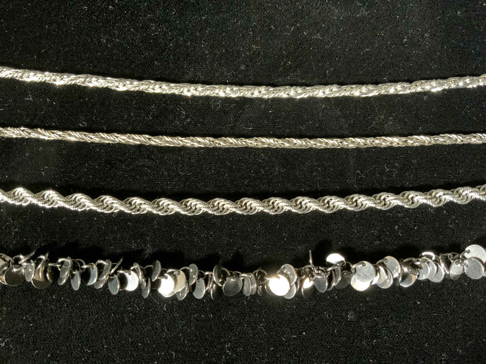 Lot 4 Silver toned Metal Fashion Necklaces: Lot 4 Chain Necklaces, no apparent inscriptions or marks, necklace with screw clasp measures 30 1/8 inches long, mesh chain necklace missing clasp, measures 38 inches long, rope chain necklace with sp