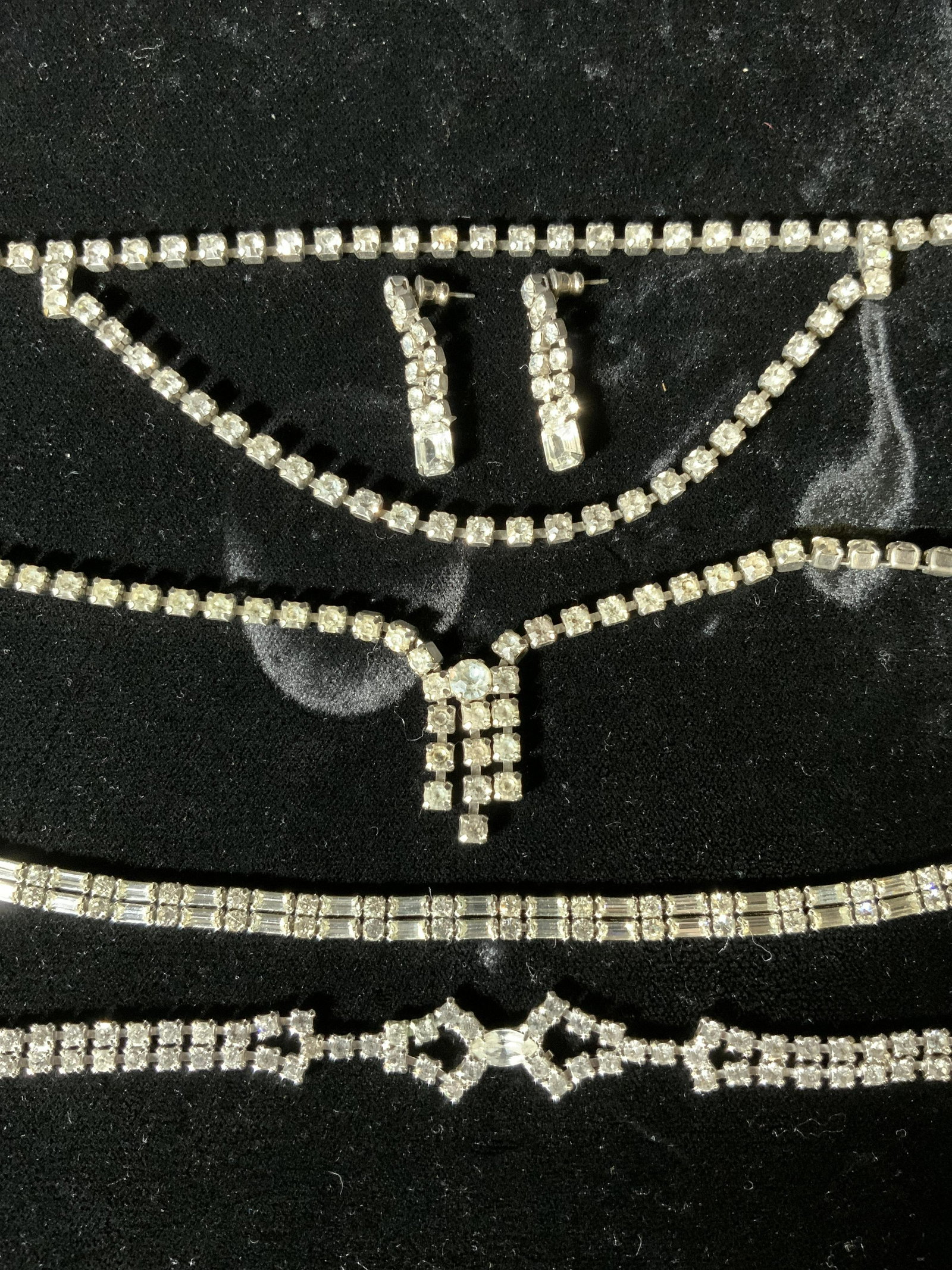 Lot 6 Rhinestone Necklaces, Bracelet, & Earrings: Lot 6 Rhinestoned Necklaces, Bracelet, & Earrings, inscription to lobster clasp necklace reads ‘Icing’, measures 16 3/8 inches long, bracelet with fold over clasp measures 7 1/8 inches long, hook 