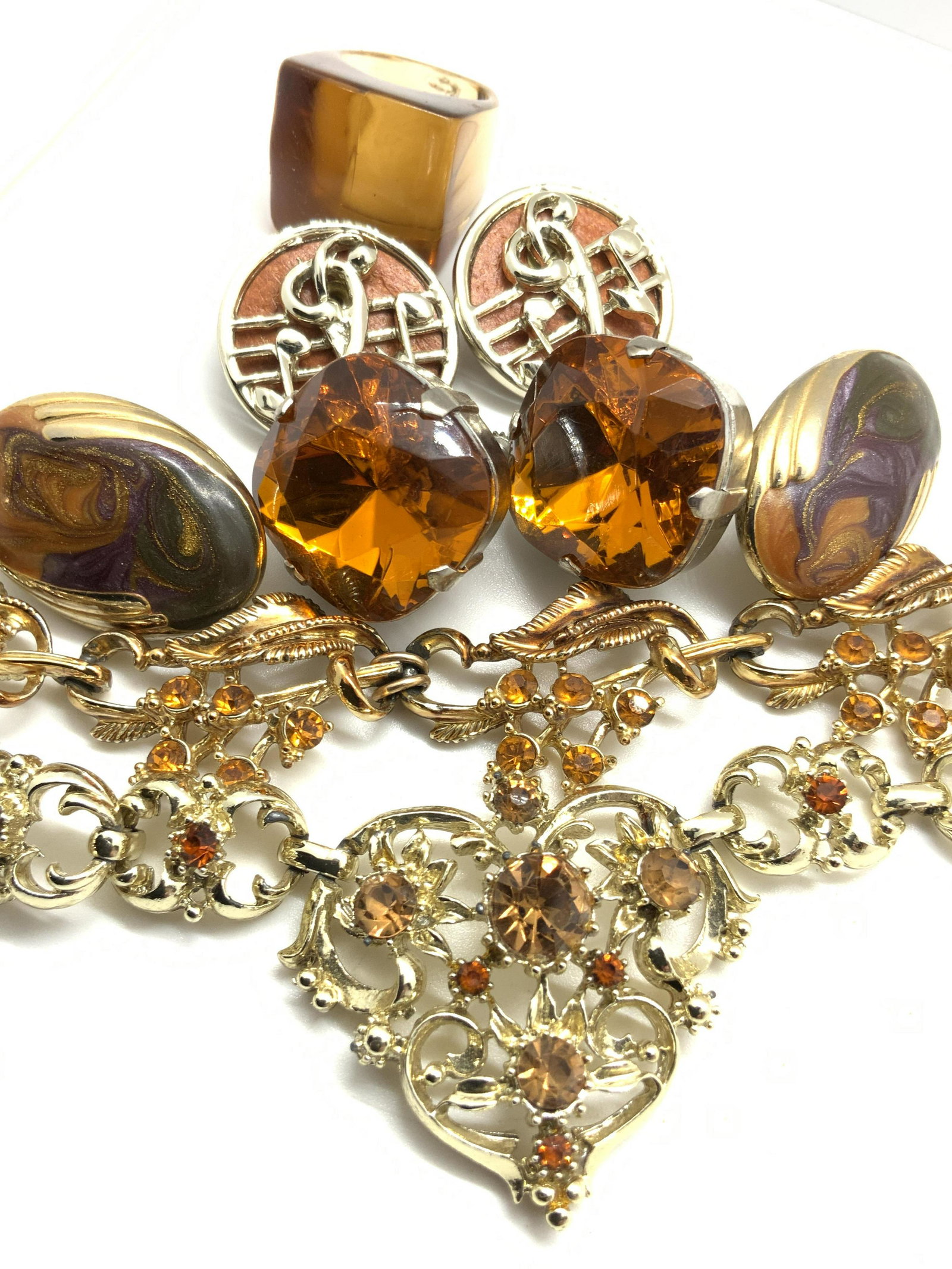 Lot 6 NAPIER, CORO Signed Amber Tn Jewelry & More: Six pieces of jewelry that can be worn together or separately. Three pairs of earrings, two necklaces, and more ring. Pieces are crafted from gold and silver tone metals. Both necklaces are signed on