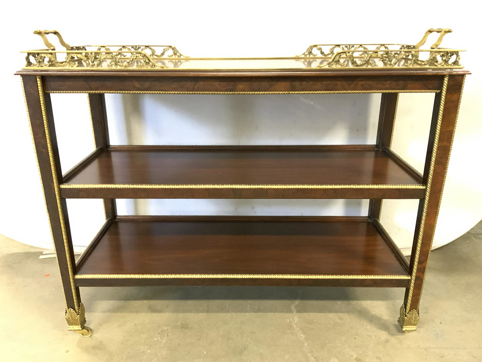 HENREDON Wooden Bar Cart W Brass Accents: Underside of cart top Is labeled HENREDON FURNITURE INDUSTRIES. Cart is chocolate toned and wooden. Piece has gold toned brass handles and partial ornate galleries with continuous s scroll structures.
