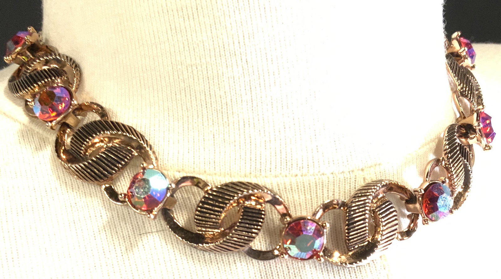 Aurora Borealis Cocktail Choker Necklace, Jewelry: Choker Necklace with sizable 9 mm pink crystals interspersed with etched rose gold toned metal. Fleur de lis charm to back. 13-15 in. Crystal fell out and is with piece to be re glued. Aurora Borealis