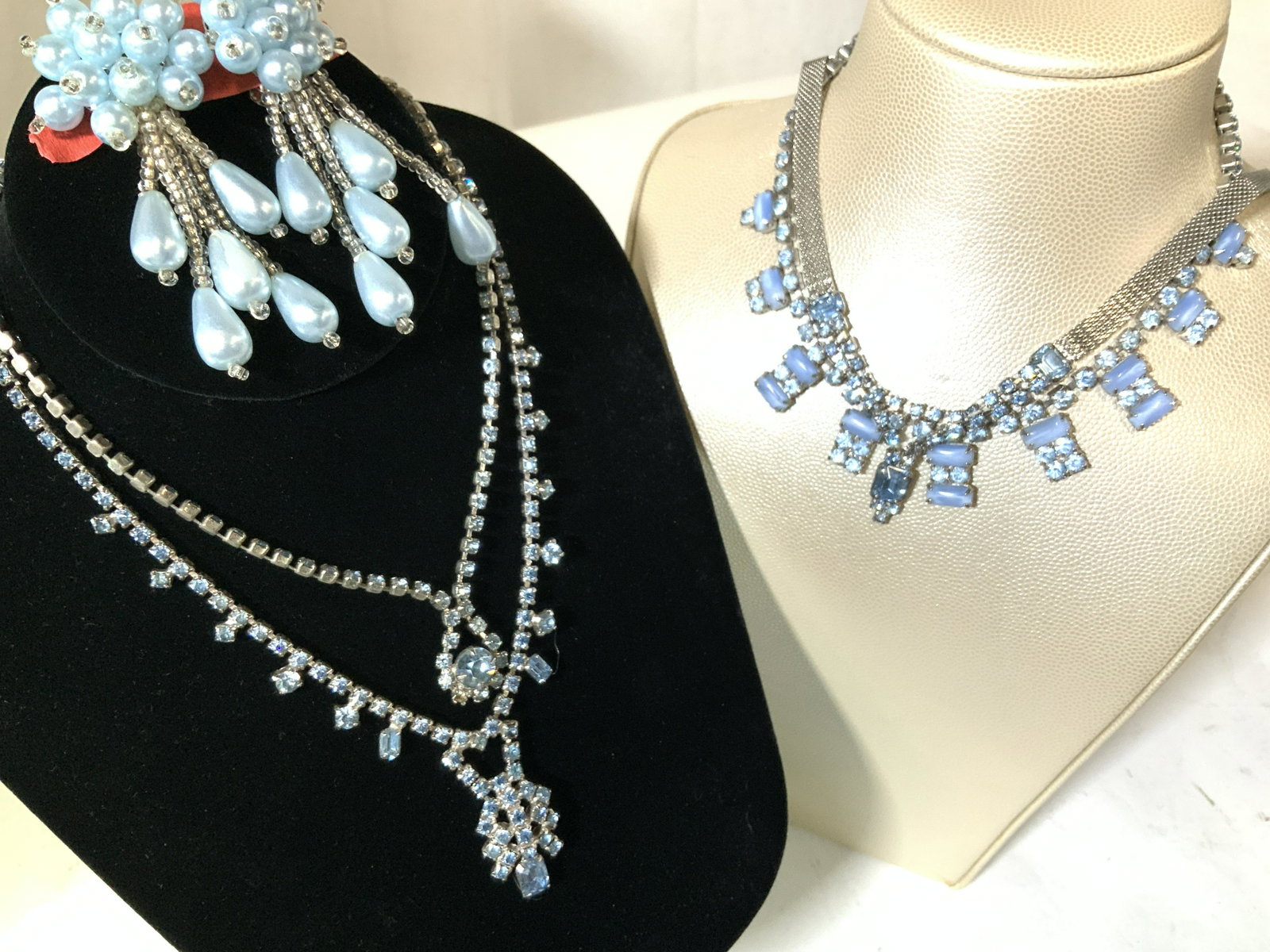 Grp 5 Blue toned Rhinestone Pendant Necklaces,more: Total items 6, or clip on earrings and 4 necklaces. Tassel faux pearl & seed bead clip on earrings in baby blue. 1 clip needs padding, loose. Various blue topaz color rhinestone necklaces, one with me