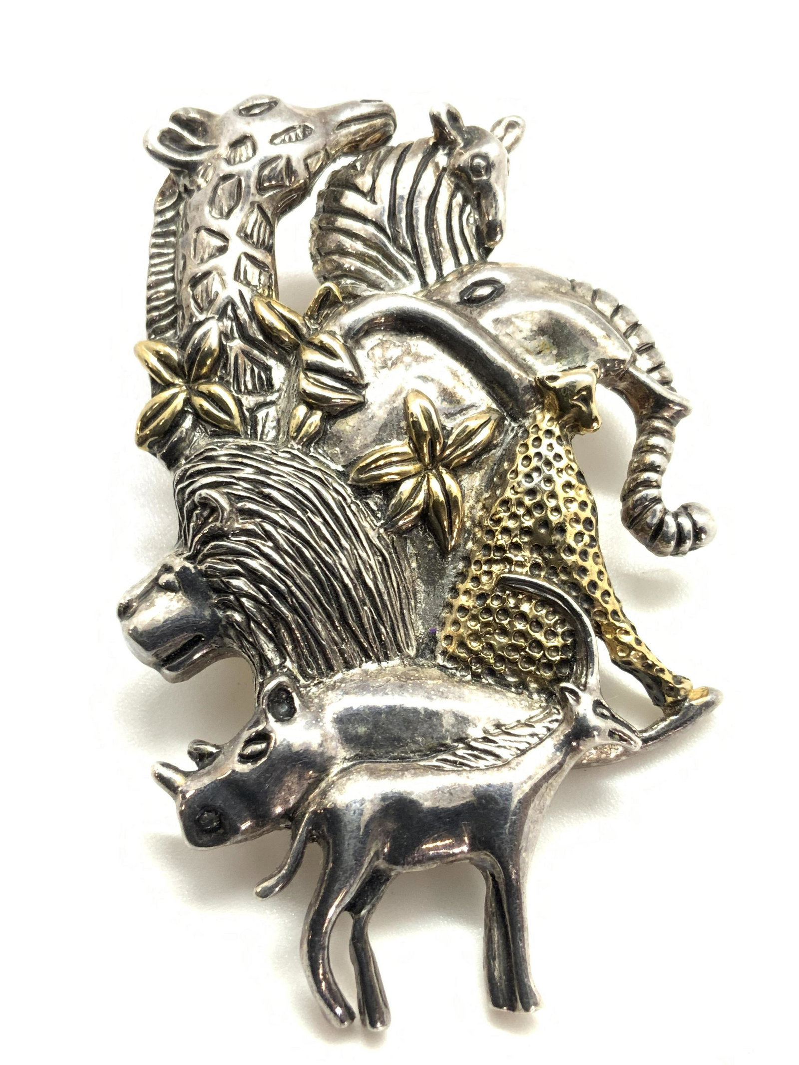 SAFARI ANIMAL Brooch / Pendant, Jewelry: A multi purpose jewelry piece that features a bail and a metal pin closure on the underside. Can be used as a brooch or necklace pendant. The piece features gold and silver tone metal crafted into the