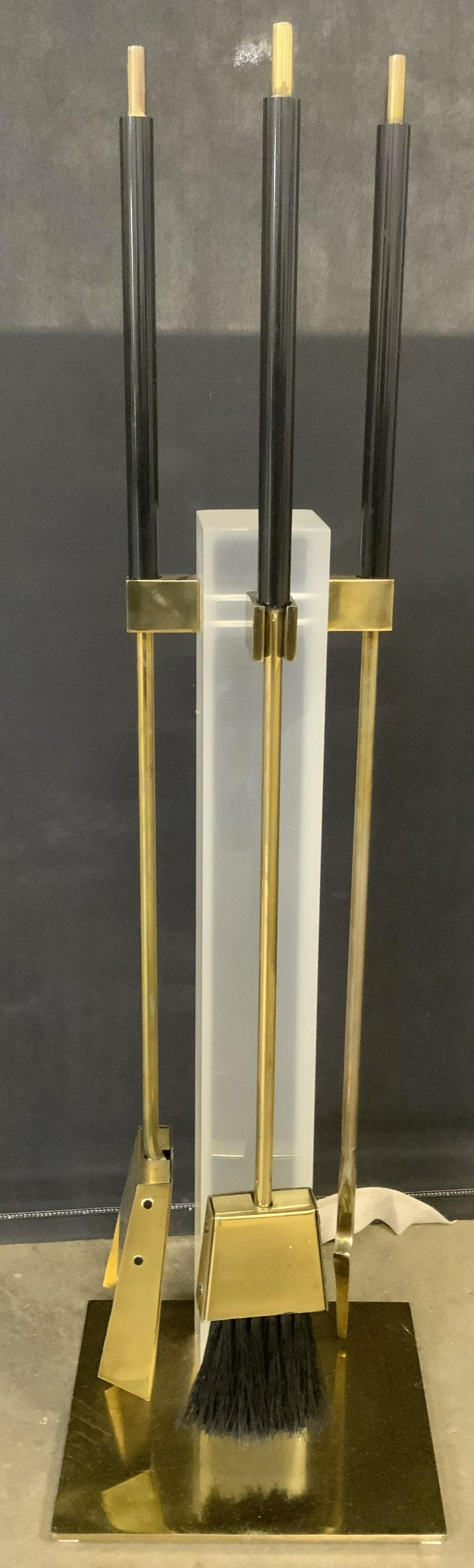 Set 4 Brass & Lucite Fireplace Tools & Stand: Lot includes fireplace tool stand, shovel, broom, & poker. Base of tool stand & fireplace tools are gold toned and brass. Stand support is lucite. When put together, measures approx 35 inches tall 10 