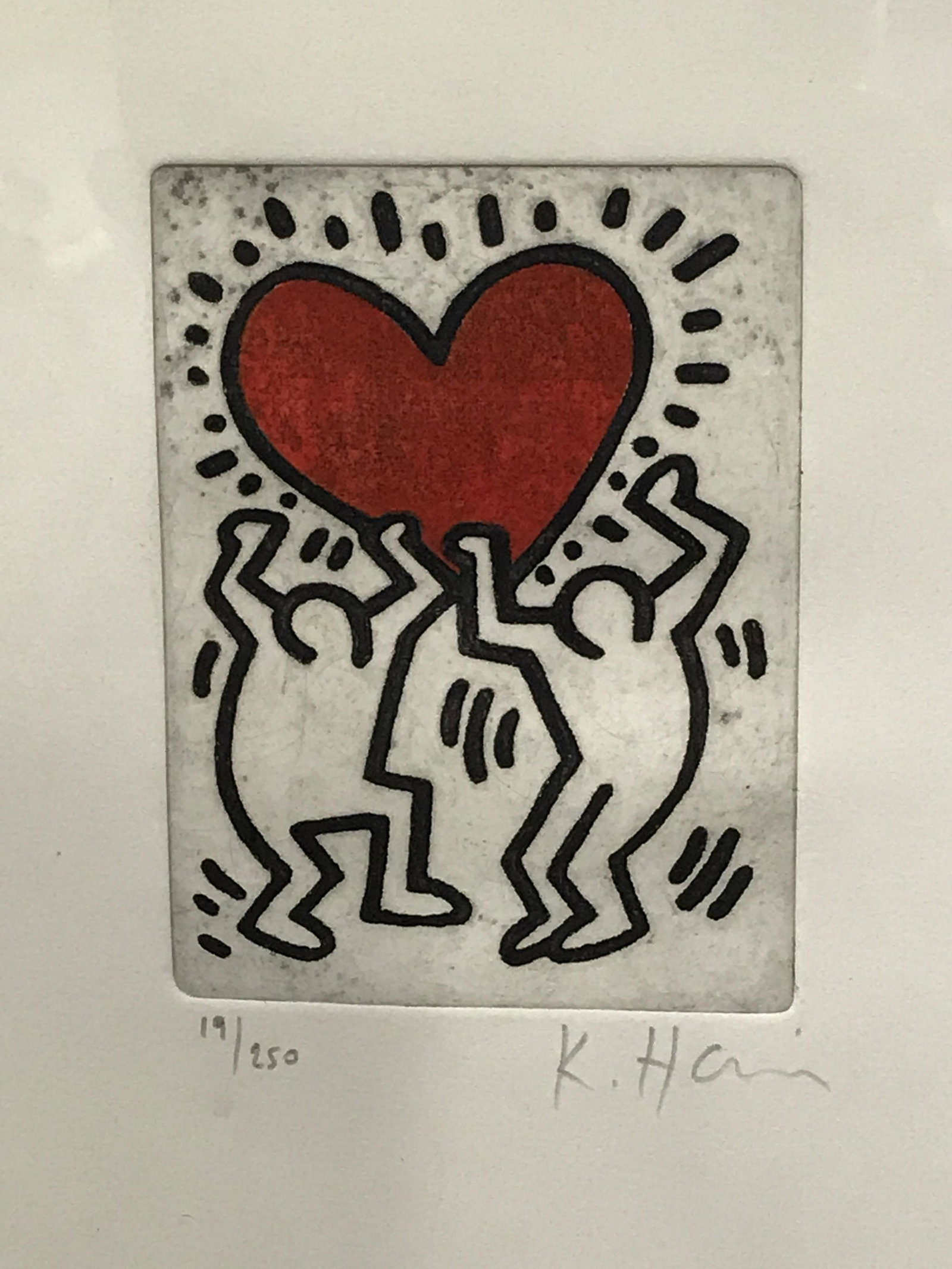 Keith Haring Signed Ltd Ed Lithograph: Keith Haring signed limited edition lithograph, signature to the lower right corner reads ‘K.Haring’, edition to the lower left corner reads ‘19/250’, subject two dancing figures holding up a 