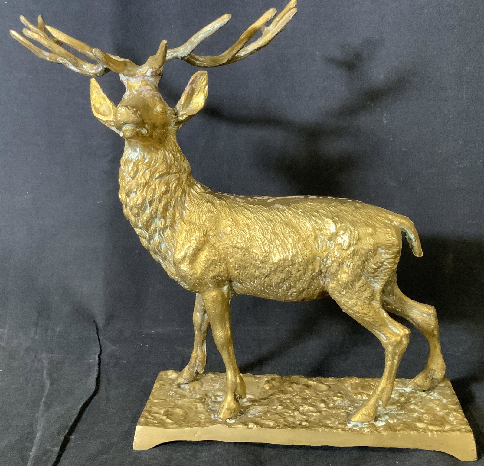 GILT BRONZE WILDLIFE STAG SCULPTURE: Wildlife Red Deer/ Stag Figural on base, etched metal, brightly gilt patina, hammered metal style base. Heavy weight. App 13 in total Length, 10.5 in ht, width 7 in. Gilt bronze Stag sculpture, luxury