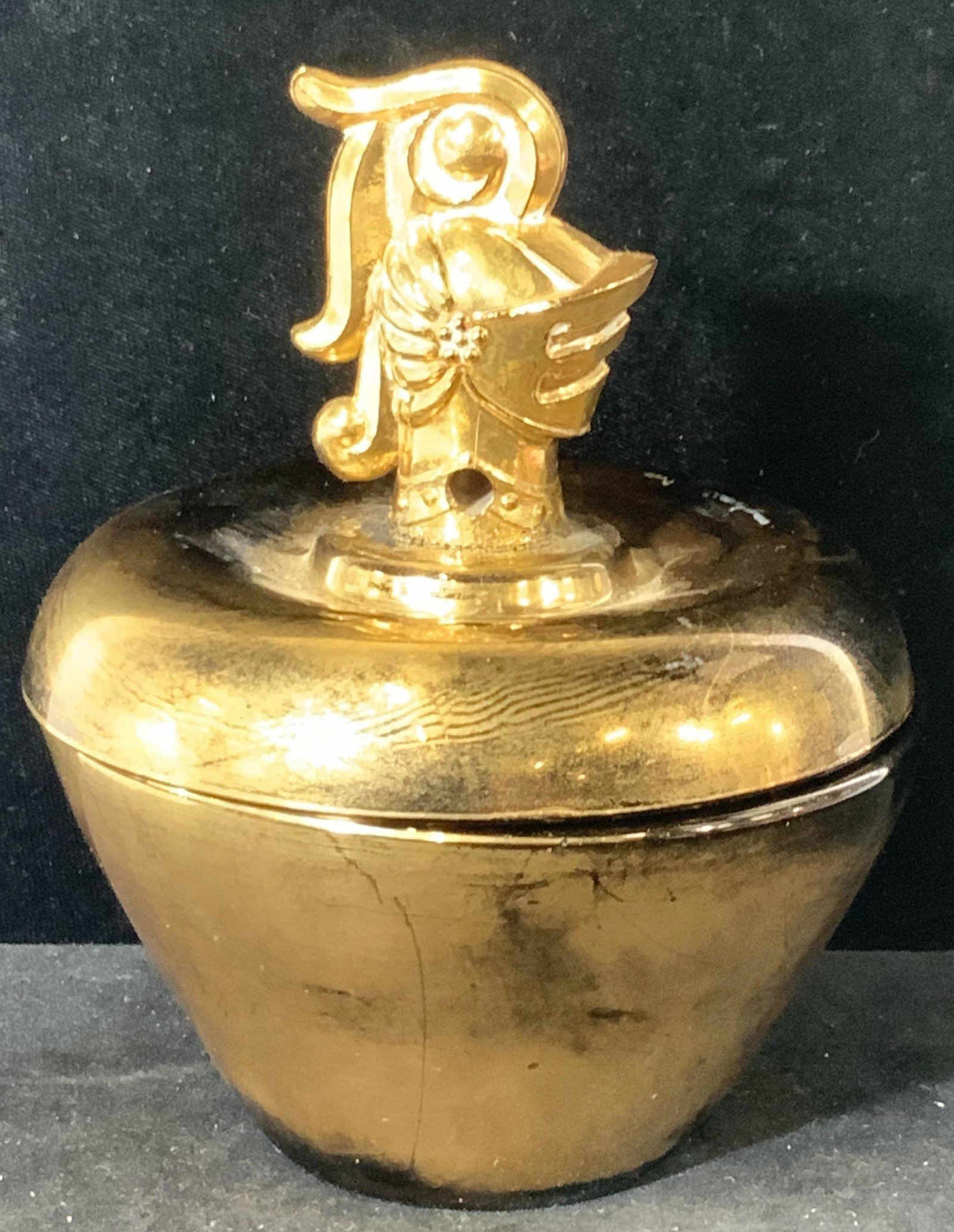 Legionnaire Finial Art Glass Trinket Bowl: Gold & Black thick walled glass bowl with lid. Finial is figural suit of armor form head bust. Interior black glass with a gilt exterior patina. 5.5 in ht, app 4.5 in. W. Depth of bowl app 2 in. Finia