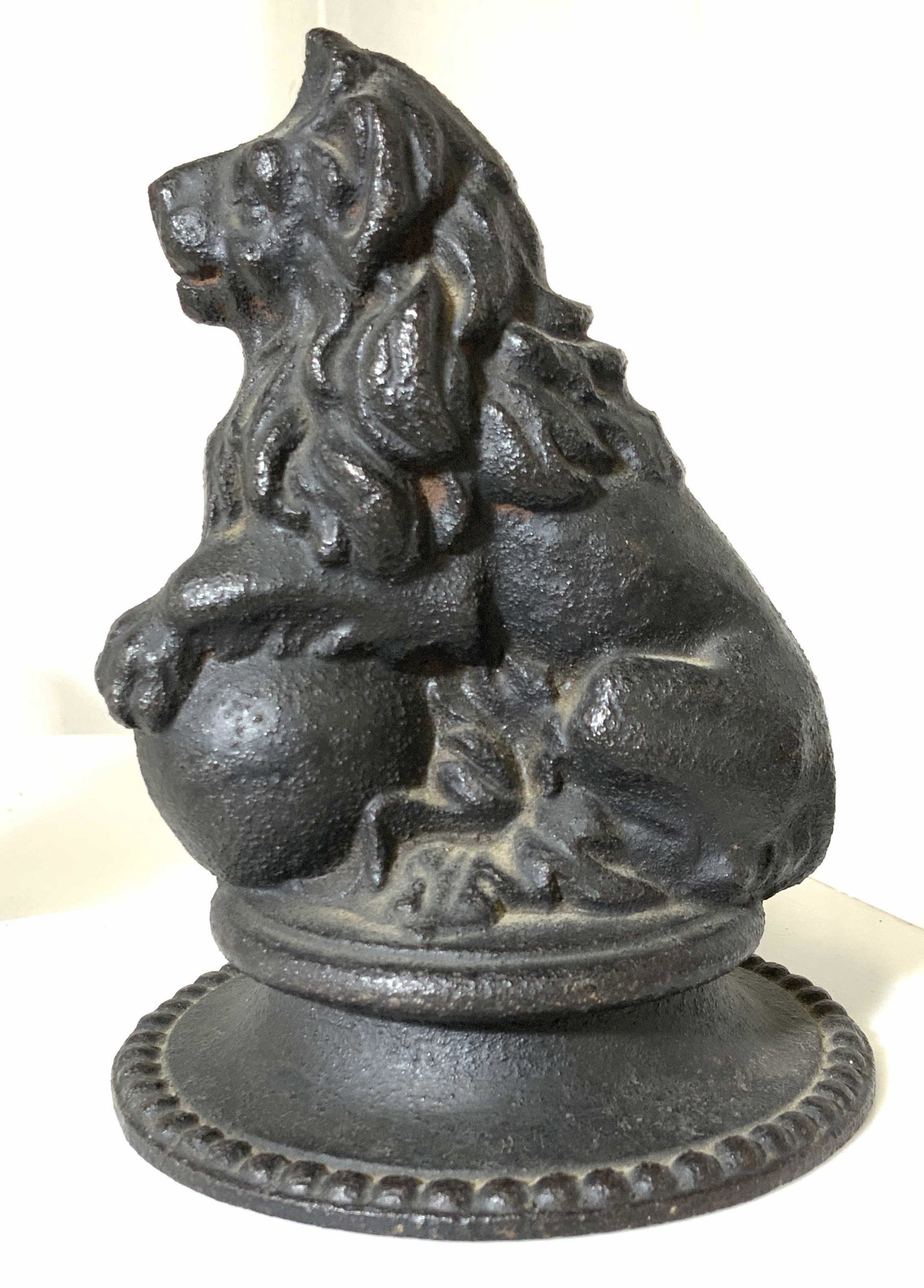ANTIQUE IRON LION FIGURAL W/ BALL: Cast iron lion with paw resting on ball. Antique decorative arts just under 6 in. Ht, 4 in. base diameter. Similar to the enormous Lion of Congress Deputies in Madrid. Daoiz, Cast Iron Lion figural, A