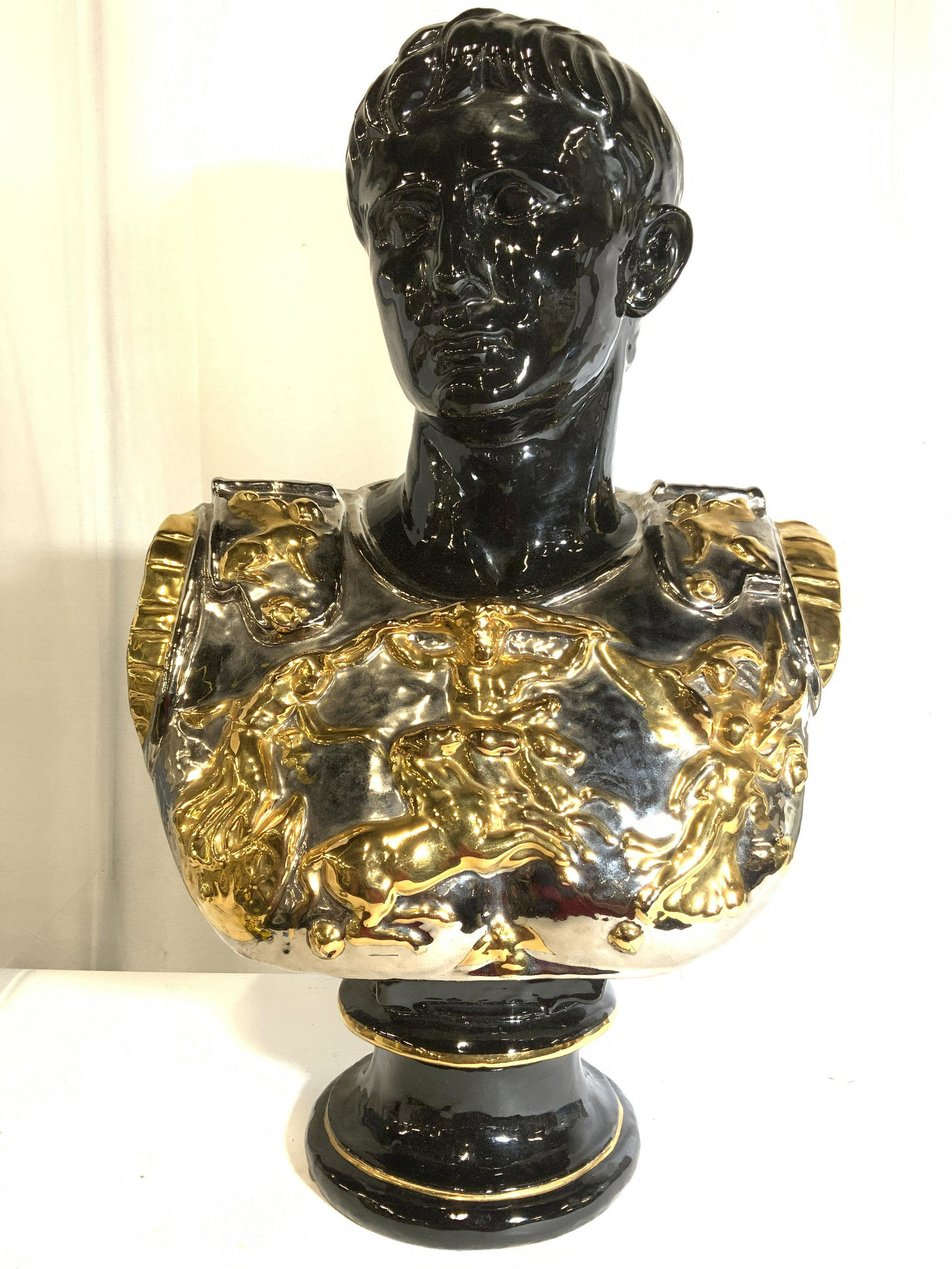 Signed Trademarked Italian Terra Cotta Soldier: Underside has illegible trademark and signature. Underside is also marked MADE IN ITALY. Piece appear to be terra cotta, possibly ceramic. Bust depicts a male soldier wearing armor. Piece is black wit