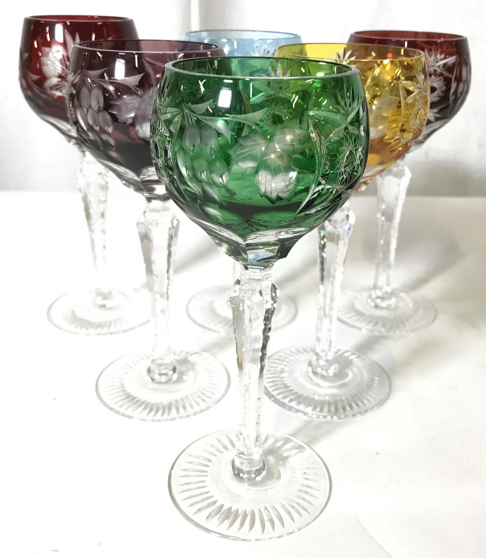 Set 6 Bohemian Art Glass Cut Crystal Goblets: Lot includes 6 goblets including 2 red, 1 purple, 1 green, 1 yellow, and 1 ice blue toned. Goblets each appear to be cut crystal with grape, vine, geometric and leaf detail. Each measures approx 7 inc