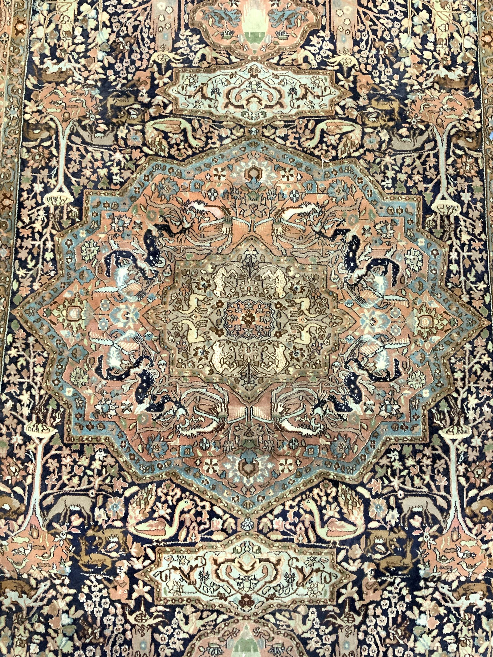 Vintage Handmade Fringed Persian Wool Rug: Rug is vintage possibly antique. Piece is handmade and wool. Contains intricate multi toned floral, leaf, vine, animal, & human figural detail. Rug has knotted fringes at edges. Piece measures approx