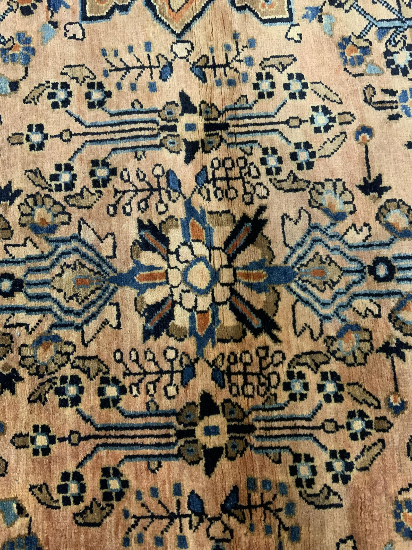 Vintage Wool Persian Area Rug: Vintage, possibly antique, wool rug, Persian style. Decorated with a multi toned floral and plant like pattern. Ends appear to have been fringed at some point in time. Possibly handmade. Measures appr