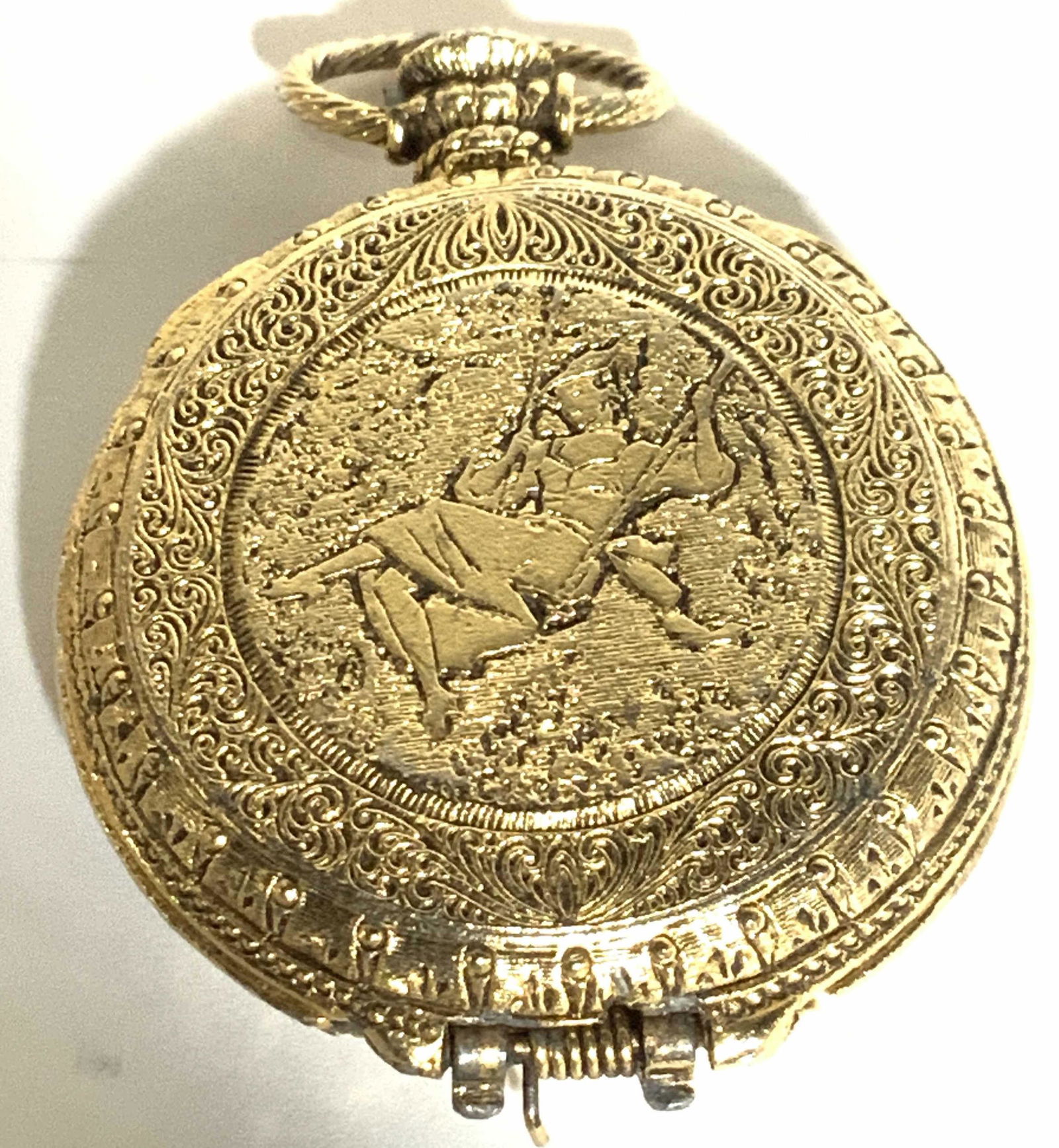 Vintage Brushed Gold Pocket Watch Pendant, Jewelry: Victorian motif, lady swinging on swing, brushed gold, gold leaf or brushed gold plated. Hinged. May need repair to snap, opens easily. Interior- space for 2 pictures. Filigree decor of swirls. 1. 25