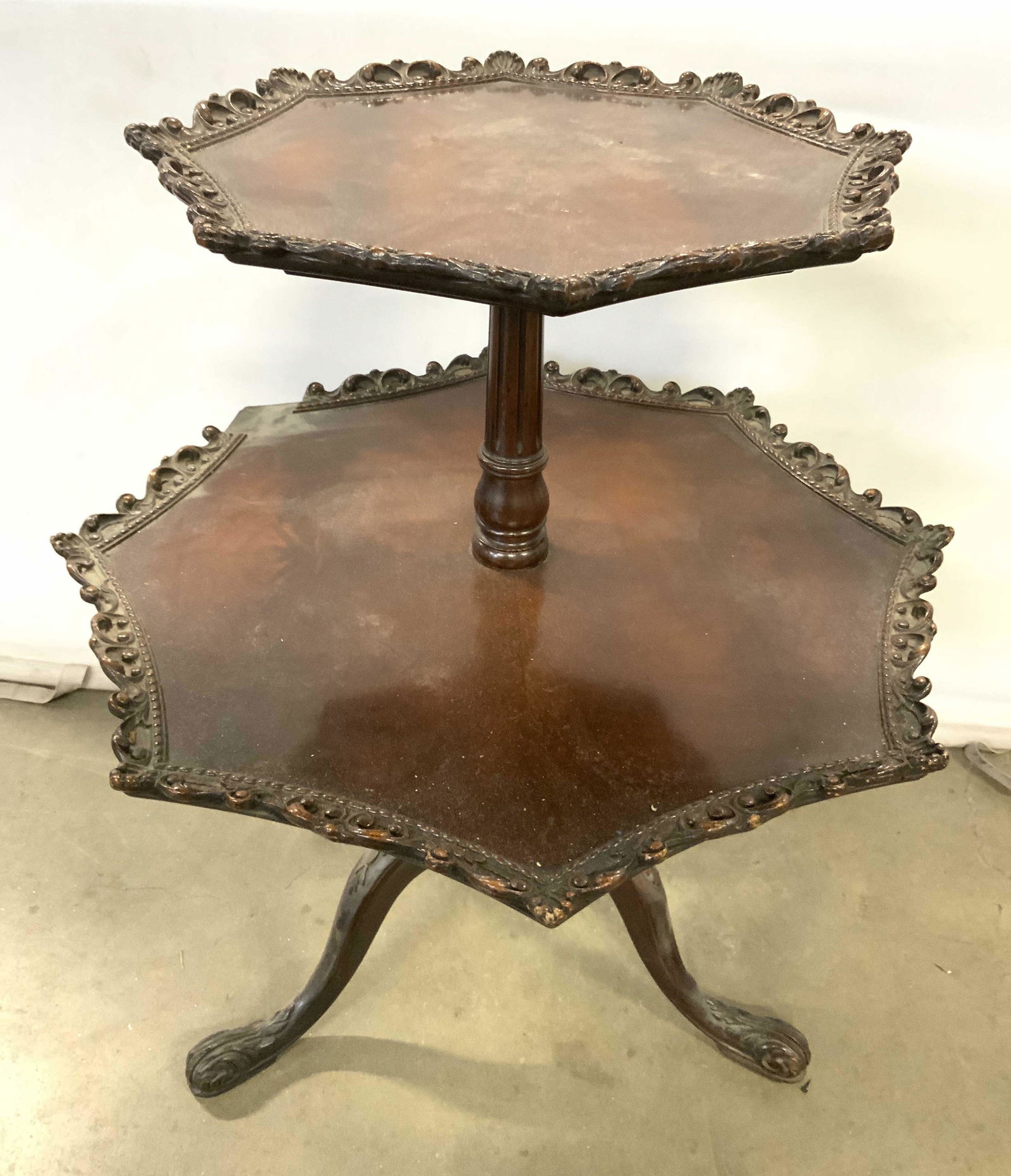 Antique 2 Tier Carved Wooden Pie Crust Table: Table is vintage possibly antique. Piece appears to possibly be mahogany. Table has small top tier with larger lower tier. Piece appears to have some hand crafted areas. Each tier has intricately carv