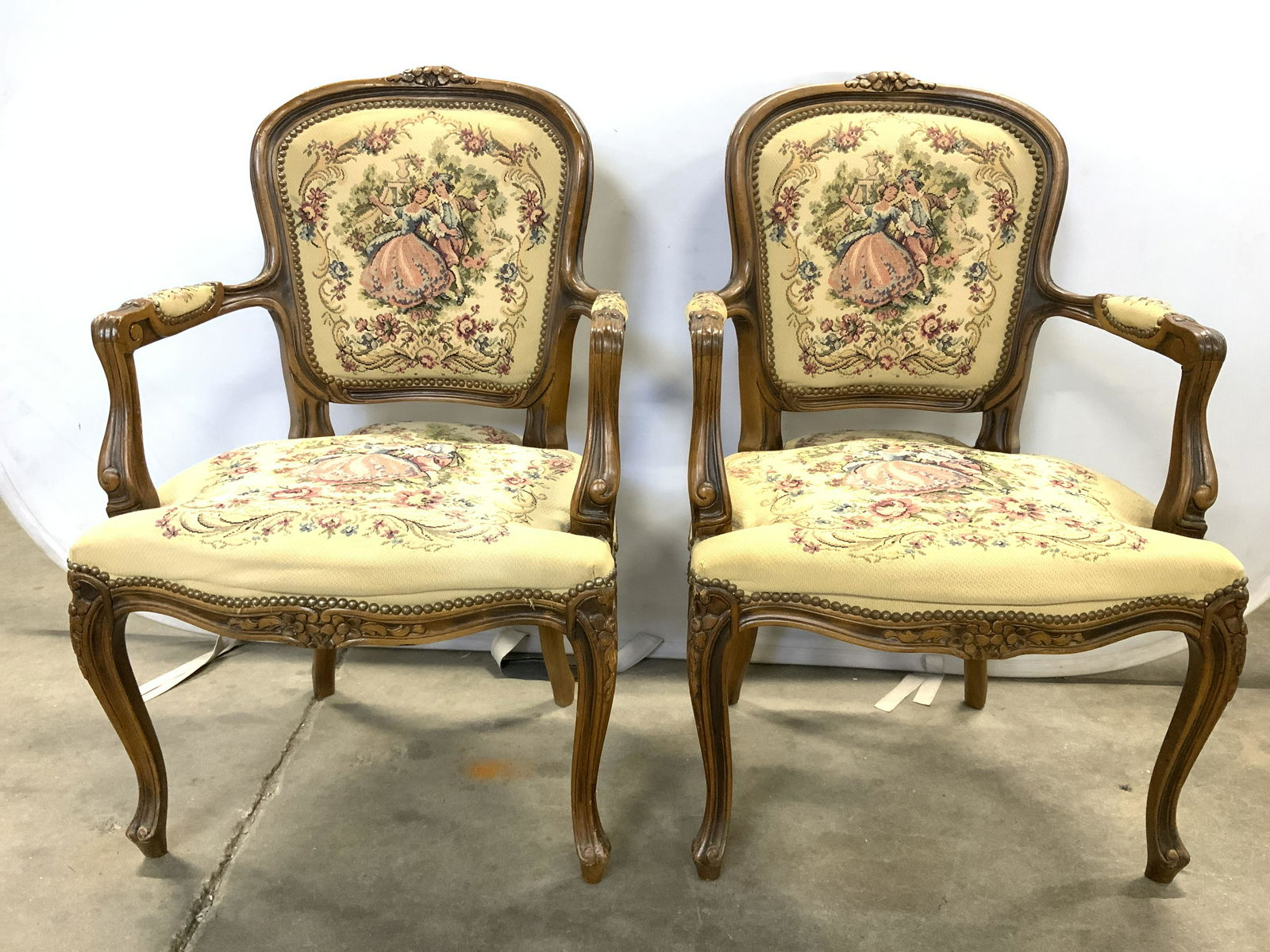Pr Labeled Antq French Bergere Needlepoint Chairs: Label on underside reads CHATEAU D’AX SPA VIA NAZ. Chairs are antique. Wooden frames appear to be hand carved. Wooden carvings have floral & leaf detail. Needlepoint upholstery appears to be hand ma