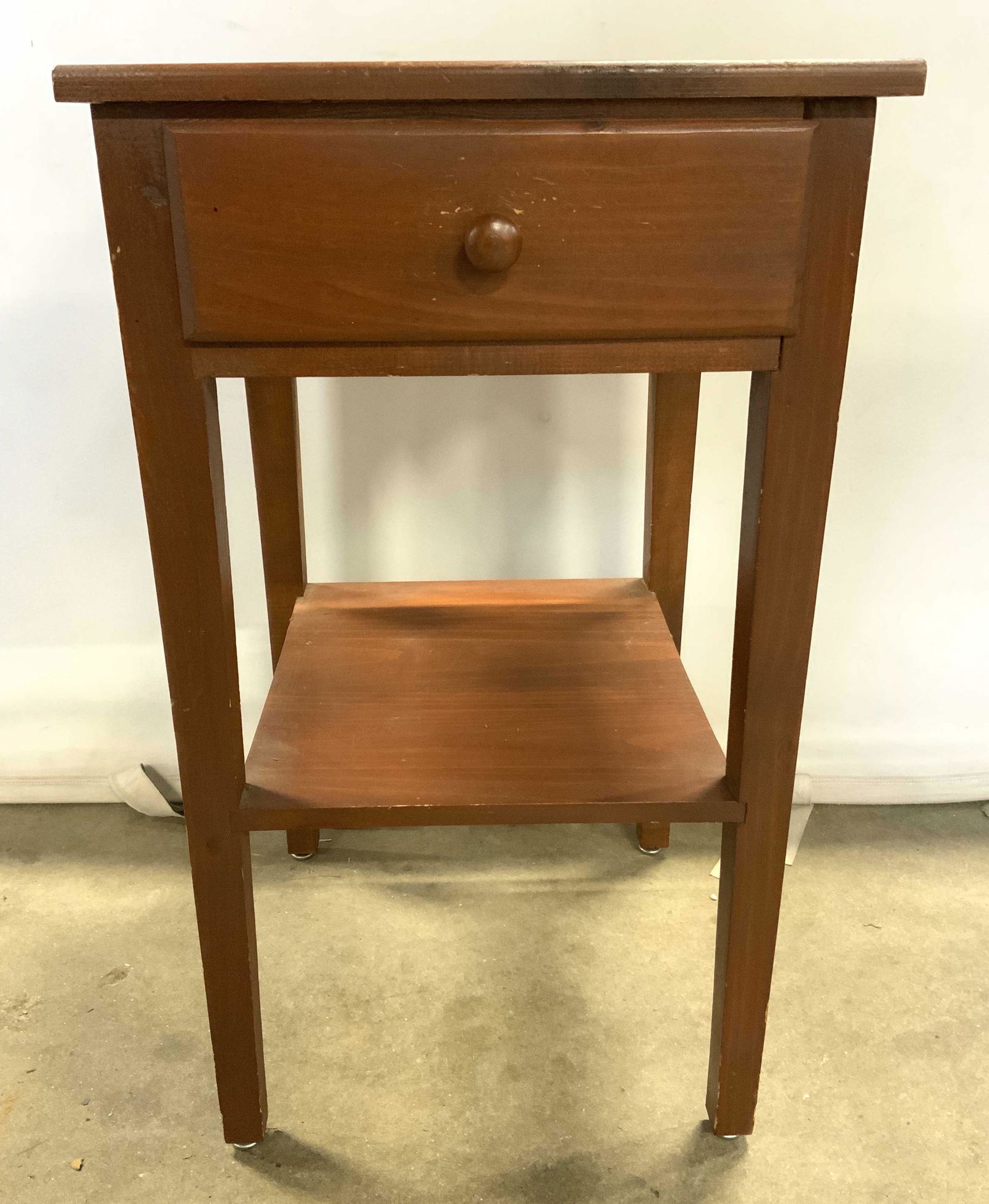 Vintage Wooden Side Table W Drawer: Side table is vintage possibly antique. Piece has a light brown mahogany toned. Table has 1 drawer with wooden knob style handle. Table has 4 wooden legs with board stretcher in between. Piece measure