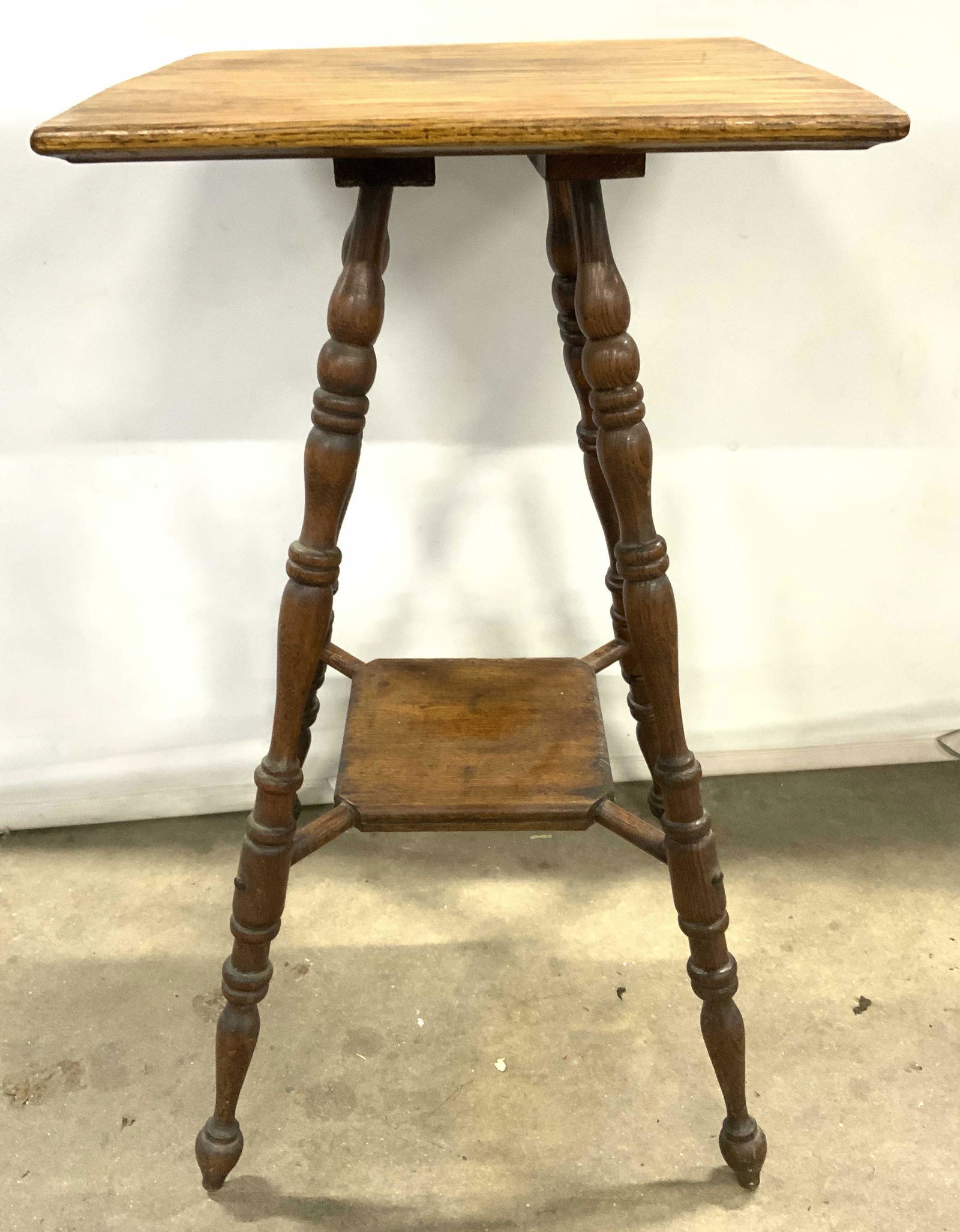 Antique 2 Tier Parlor Lamp Table Side Table: Lamp table is vintage possibly antique. Piece appears to possibly be maple. Table has carved wooden relief detail directly under top. Table has slightly curved splayed legs with board stretcher in bet