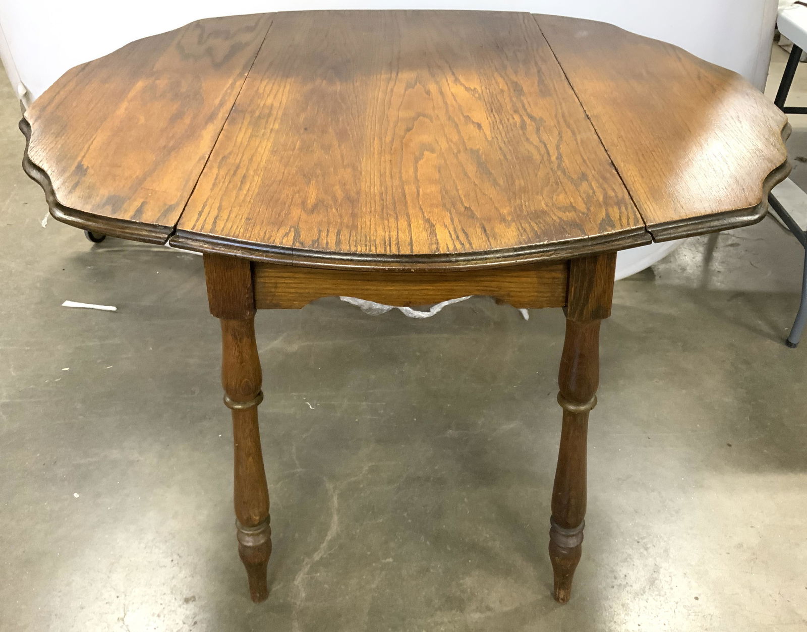 Vintage Carved Wooden Drop Leaf Dining Table: Table is vintage possibly antique. Piece appears to possibly be hand crafted. Table has 2 fold down drop leafs. Table has 4 carved wooden legs which are splayed slightly outward. Piece with leafs meas
