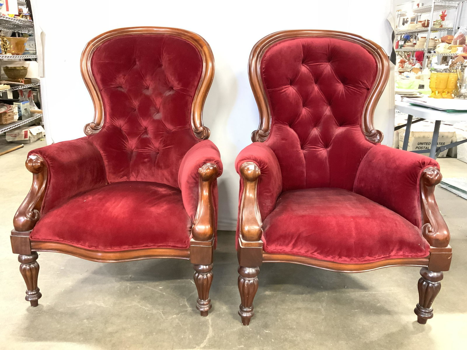 Pr Antique Victorian Ballon Back Tufted Armchairs: Lot includes 2 armchairs. Each chair is antique. Upholstery has a deep cranberry tone with welting at edges. Backrest is tufted. Piece has intricately carved wooden detail. Each measures approx 43 inc