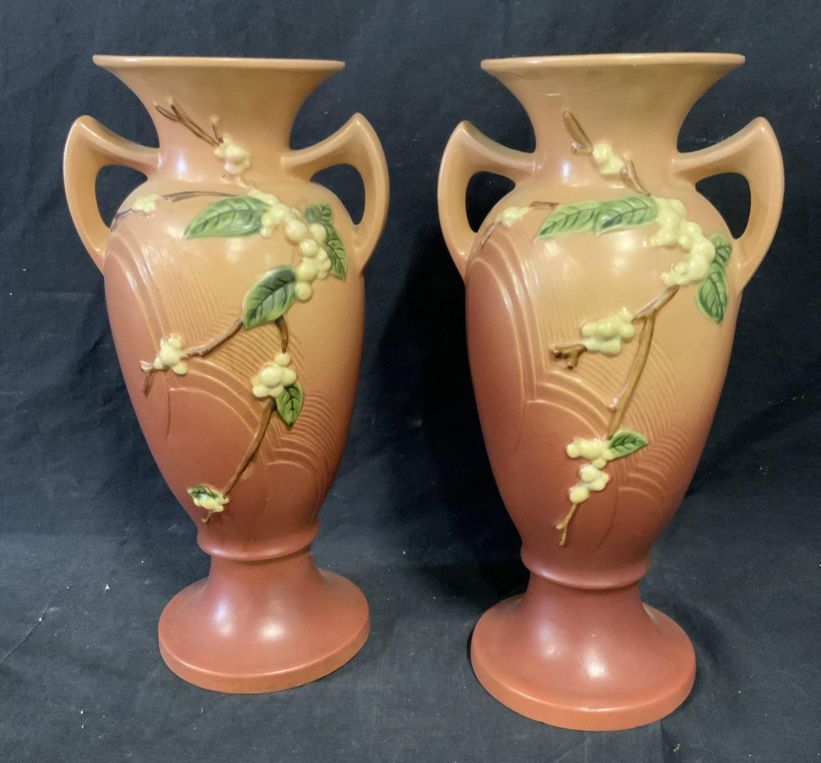Pair Cherry Blossom Roseville Vases: Pair cherry blossom Roseville Vases, underside to both read ‘Roseville’, both have an ombré blush red to peach color as the base with white berry blossoms and leaves sprouting off branches, both 