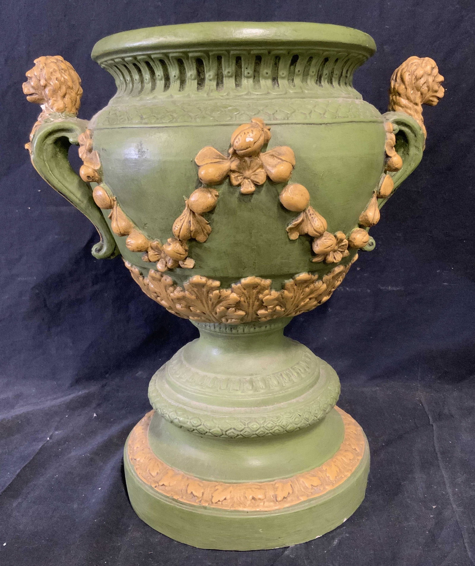 Green Outdoor Lion Handled Ceramic Planter: Green outdoor lion handled ceramic planter, no apparent inscriptions or markings, subject a green and yellow painted planter in the shape of a Grecian vase, measures 15 inches at tallest point and 9 i