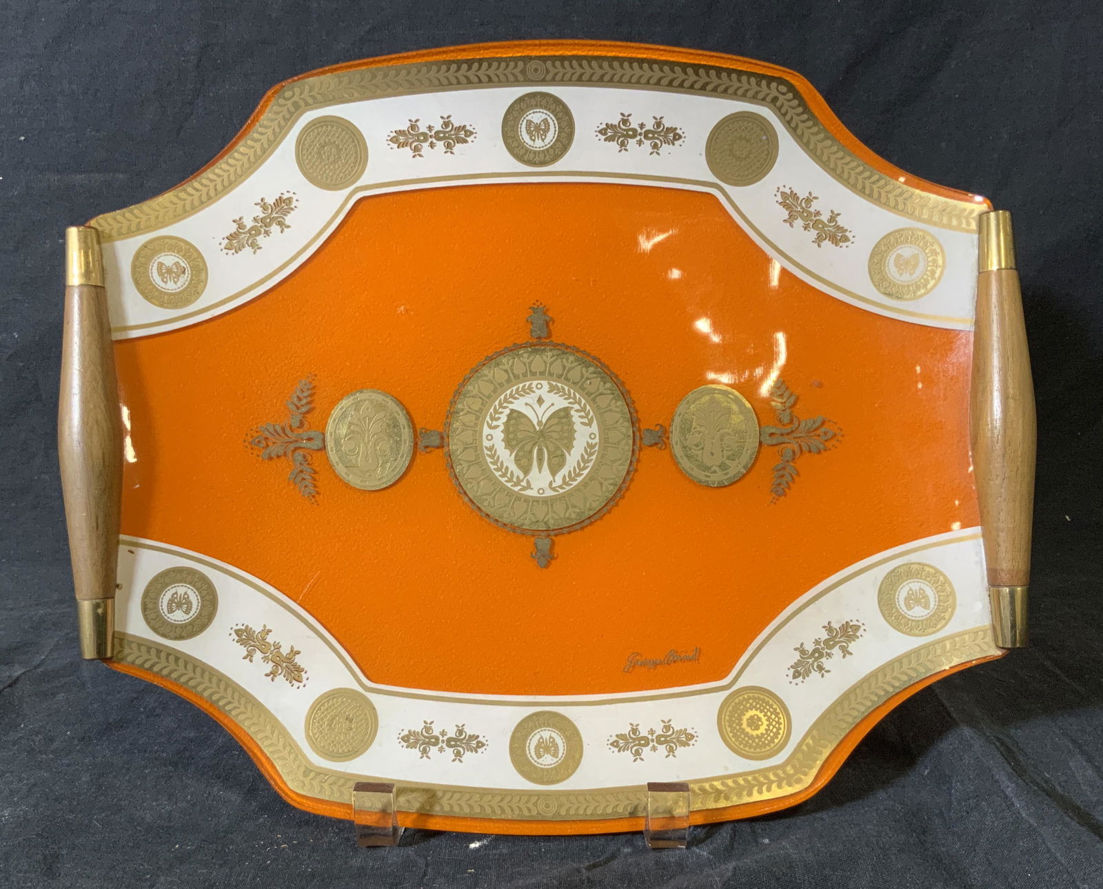 George Briard Glass Serving Tray: George’s Briard Glass Serving Tray, signature to the lower border of tray reads ‘George’s Briard’, glass tray is in orange white and gold, has wooden handles to either side, has butterfly and