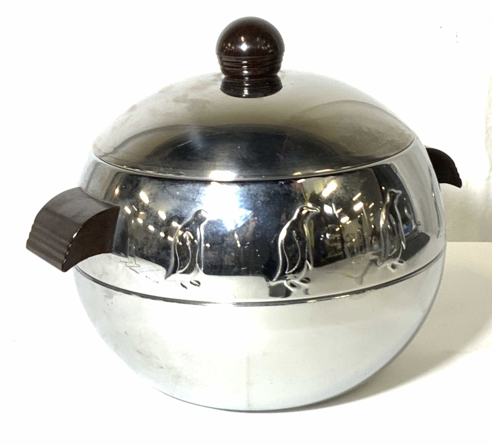 Signed WEST BEND ALUMINUM Penguin Server: An aluminum hot/cold lidded food server with embossed penguin accents. The piece is polished aluminum with composite wood style handles & finial. Underside signed: WEST BEND PENGUIN HOT/COLD FOOD SERV