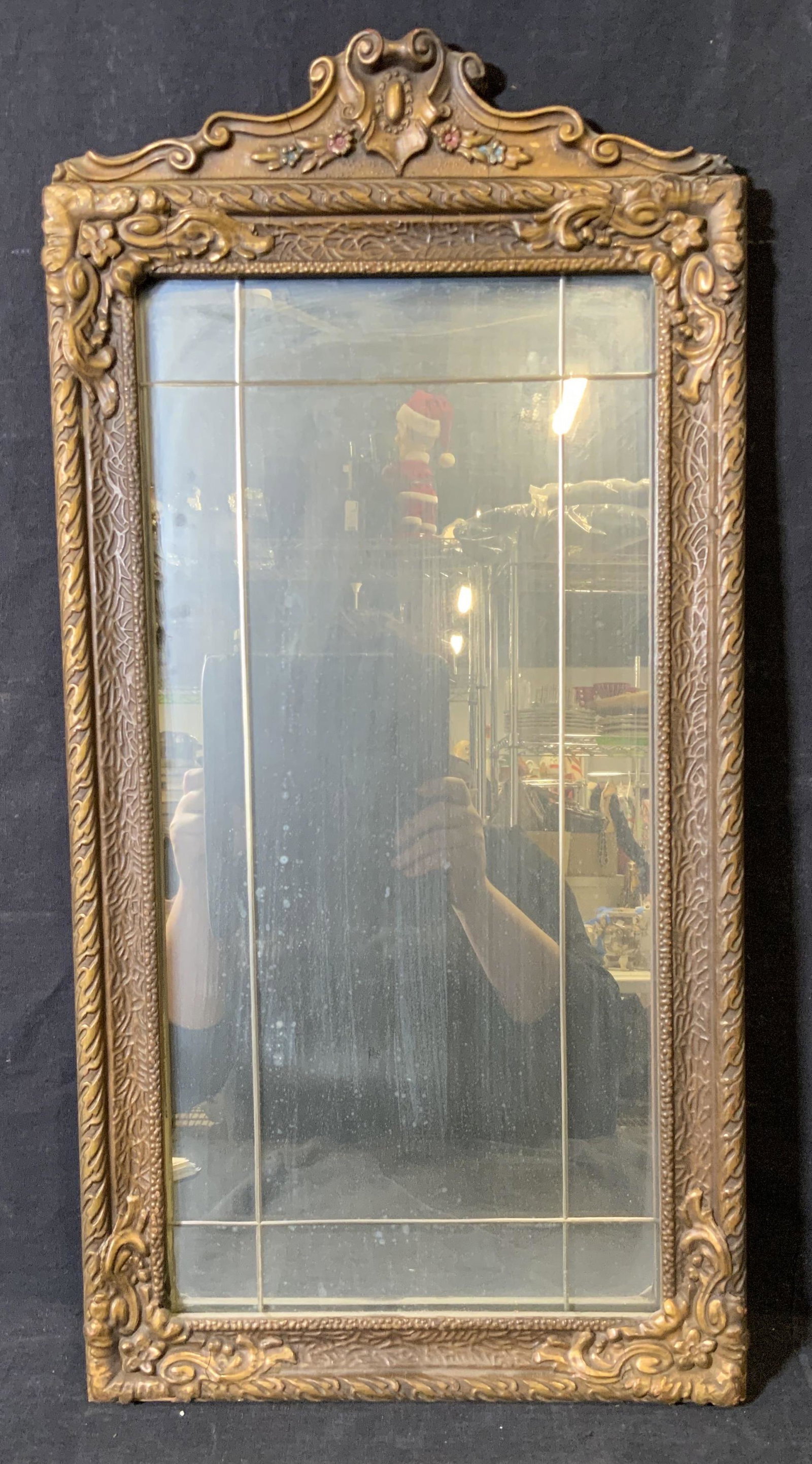 Vintage Ornate Victorian Style Mirror: Vintage possibly antique Ornate Victorian style mirror, hand carved gilt wood frame highly detailed and painted along the upper border, mirror itself has lines to the surface, some cracks to frame ove