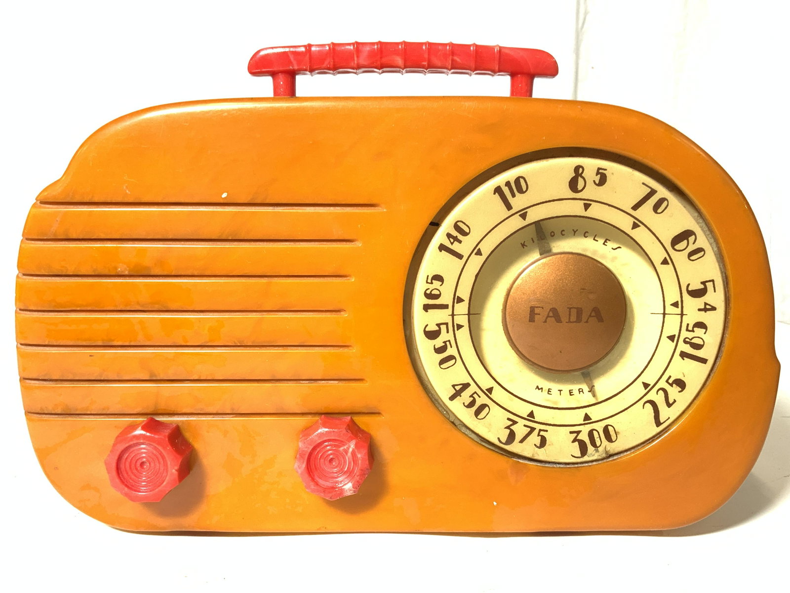 FADA 700 CLOUD Vintage Catalin Tube Radio: FADA 700 CLOUD Circa 1946-1947. Piece has red handle & knobs, orange body, cream toned face, brown toned letters & numericals. Catalin (a brand name for a thermosetting polymer popular in the 1930s an