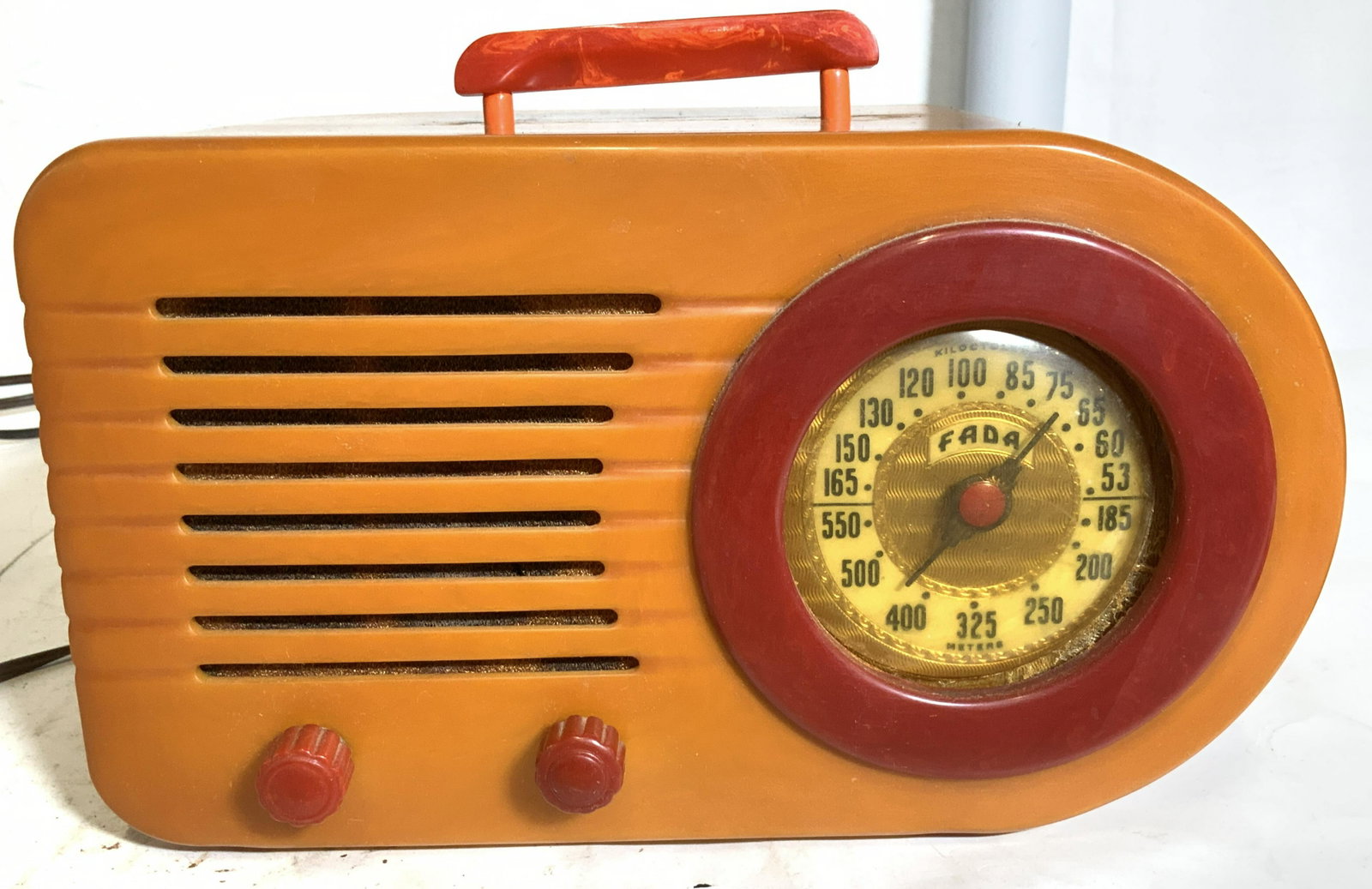 Collectible FADA 1000 Bullet Catalin Radio,: 1946. Fada Model 1000 AM Bullet Radio in Butterscotch and red, made of Catalin. stream lined designs of the Art Deco era and one of the most recognized Catalin radios from the 1930’s /1940’s. (Man